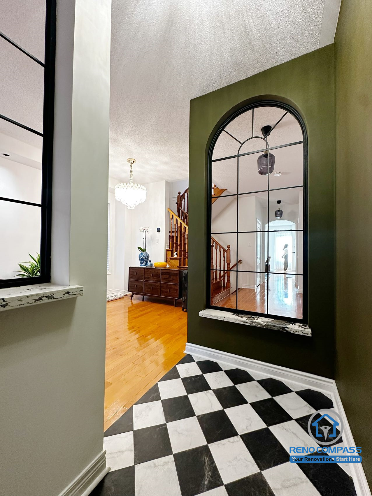 This basement renovation features a clean and functional laundry area with stacked washer and dryer, custom cabinetry, and integrated sink. The space is designed for daily use while maintaining a modern, minimal aesthetic. A glass-enclosed bathroom is seamlessly connected, improving both functionality and comfort within the basement layout.