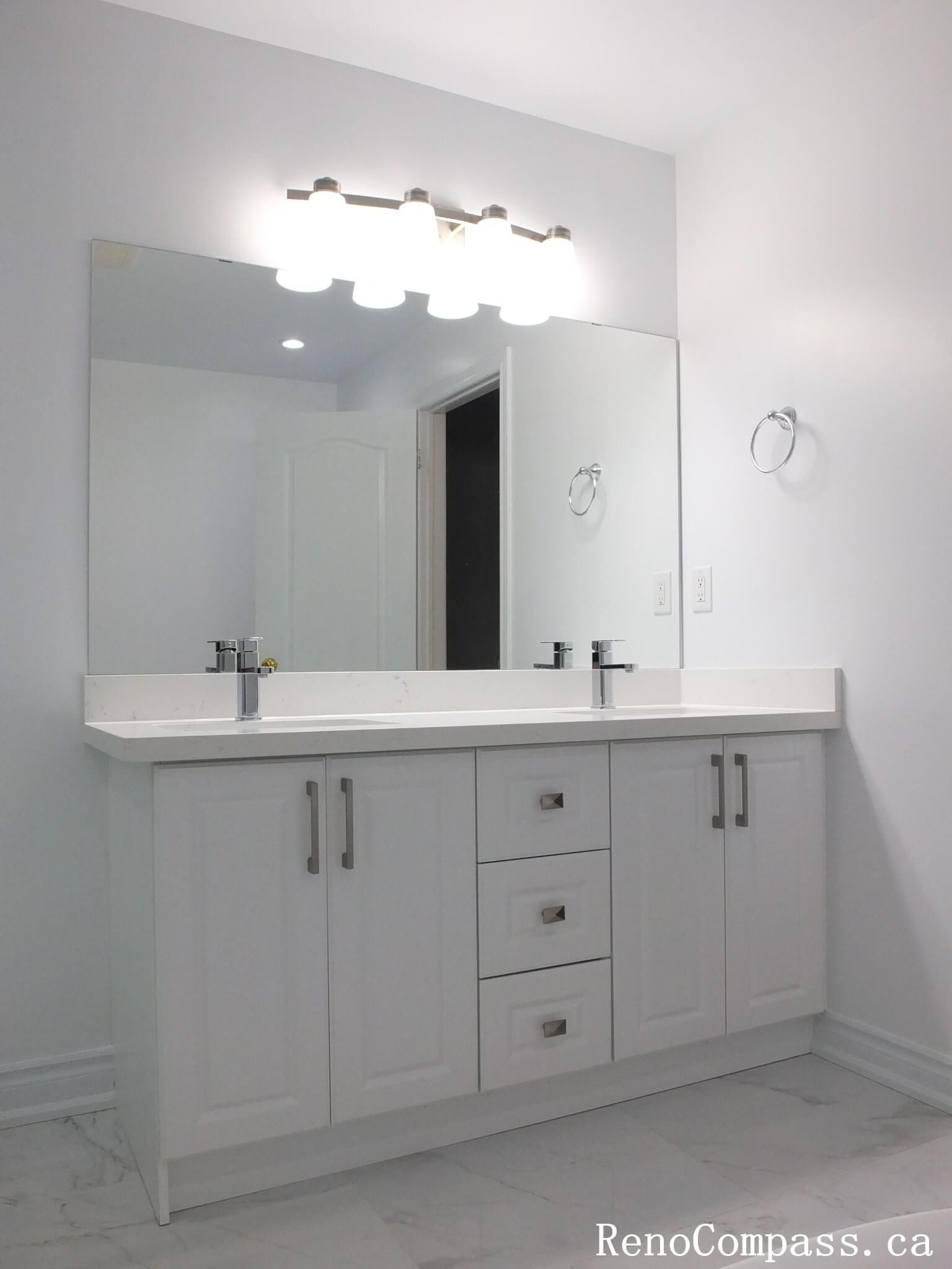 This Richmond Hill bathroom renovation showcases a contemporary double-sink vanity, frameless glass shower, and marble-look tile finishes. Completed by an experienced Toronto renovation company, the design focuses on clean lines, practical storage, and a bright, spacious layout. The combination of modern fixtures, neutral tones, and elegant materials creates a refined and functional bathroom ideal for everyday comfort and long-term durability.