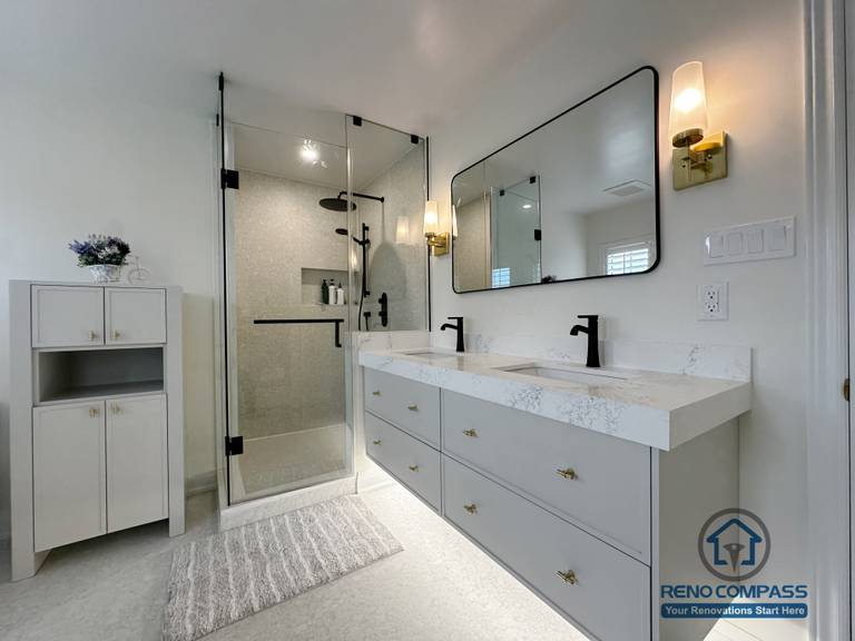This renovated Markham bathroom features a custom double vanity with quartz countertops, matte black fixtures, and a full-height glass shower enclosure. Clean lines, soft neutral tones, and well-balanced lighting create a bright, modern space designed for everyday comfort and long-term use.