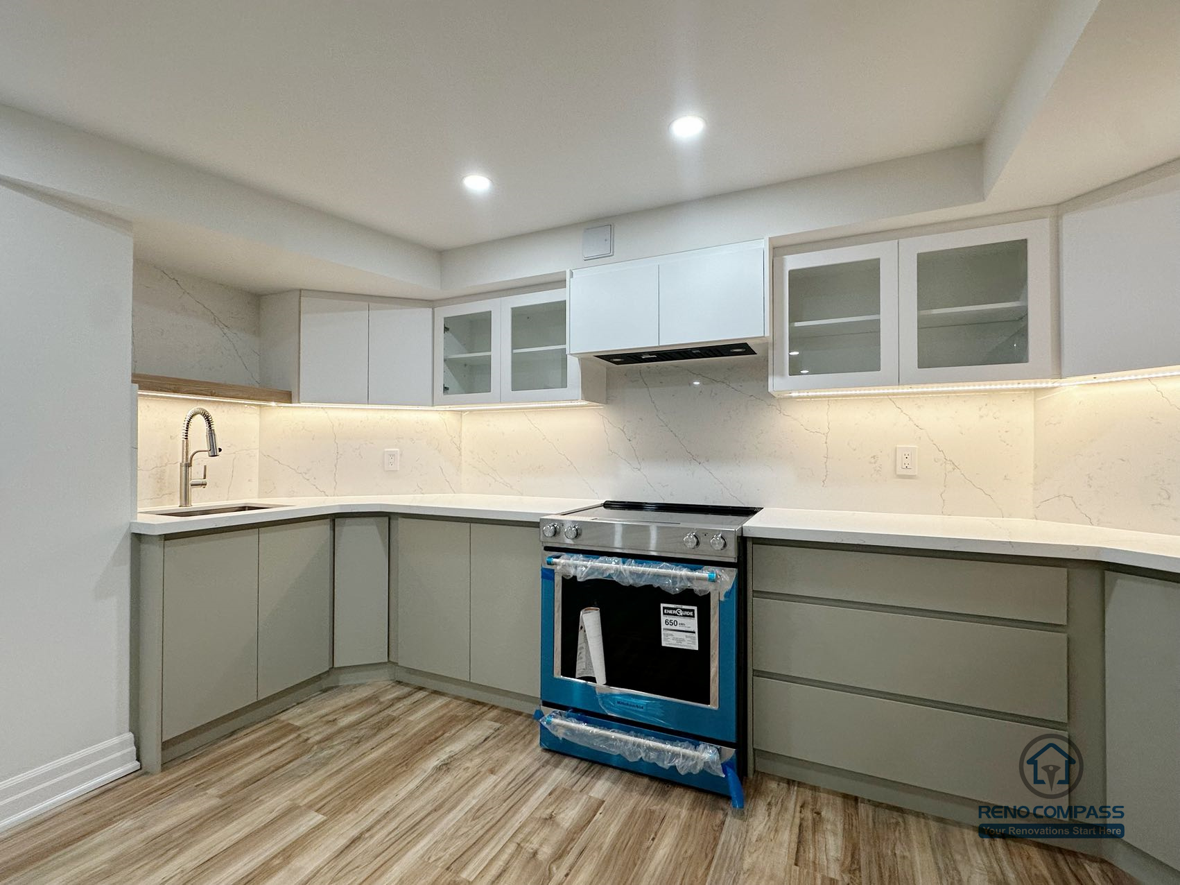 This image features a completed basement kitchen renovation in Pickering, designed to support everyday functionality within a multi-purpose lower-level living space. The layout includes custom cabinetry, integrated under-cabinet lighting, and a continuous countertop surface that enhances usability and visual clarity. Neutral-toned finishes and clean cabinet lines help maintain a bright and organized appearance, while durable flooring ensures the space can accommodate regular use. The kitchen is carefully integrated into the overall basement layout, allowing it to function seamlessly alongside living and recreational areas.
Location: Pickering · Toronto Contractor: Reno Compass