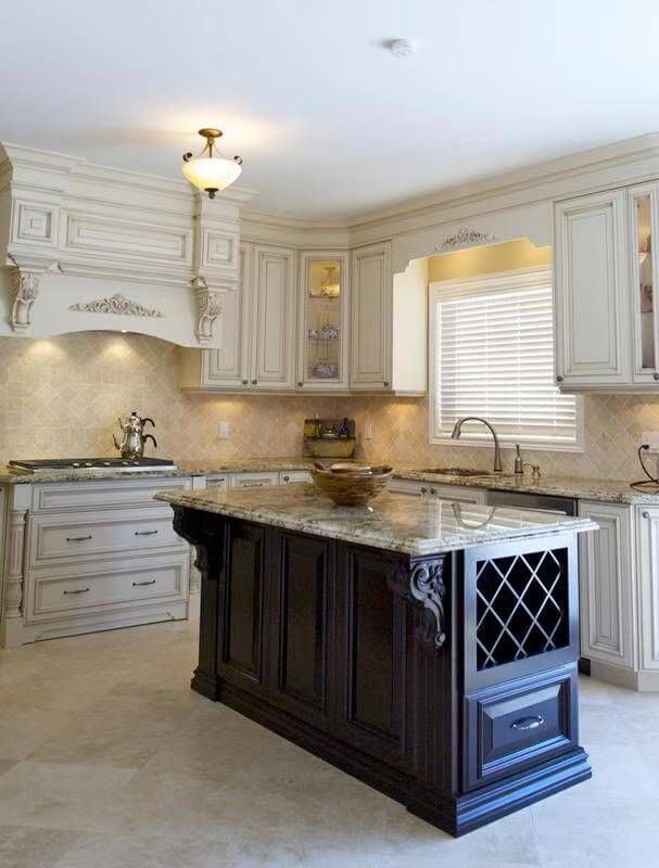 This elegant European kitchen remodel features custom white cabinetry with detailed crown molding, decorative corbels, and integrated accent lighting that enhances the architectural depth of the space. The richly finished dark wood island creates a bold contrast while incorporating built-in wine storage and additional drawer space for enhanced functionality.

The polished natural stone countertop adds durability and refinement, complementing the neutral tile backsplash and flooring. A custom-designed range hood surround serves as a sophisticated focal point, reinforcing the timeless European aesthetic.

Designed with both beauty and practicality in mind, this kitchen renovation delivers luxury craftsmanship, balanced proportions, and a classic layout ideal for upscale residential homes.