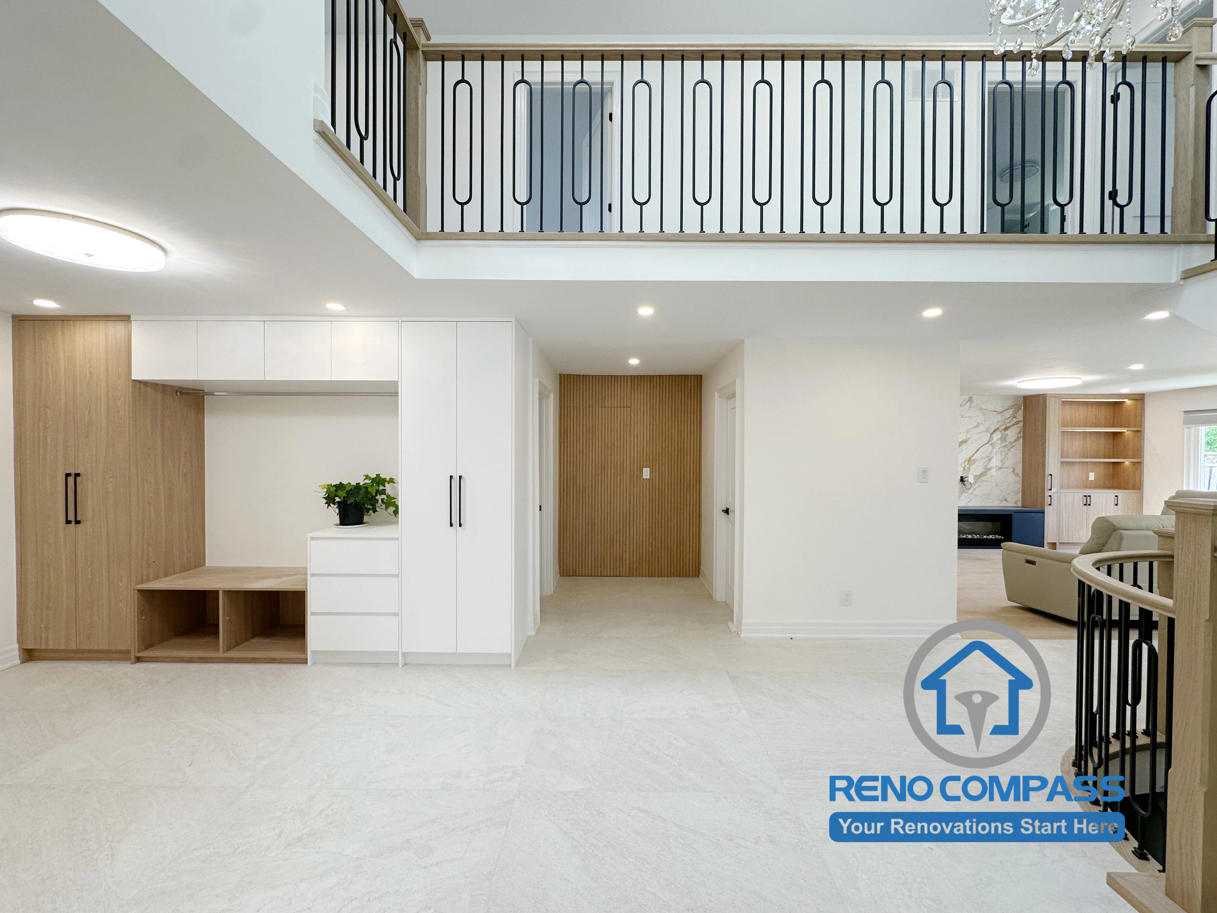 A custom mudroom with built-in cabinetry, bench seating, and integrated storage designed for a luxury home renovation in Markham, Ontario. This bright open-concept foyer features premium finishes, a double-height ceiling, modern interior design, and seamless flow into the living space, completed by Reno Compass.