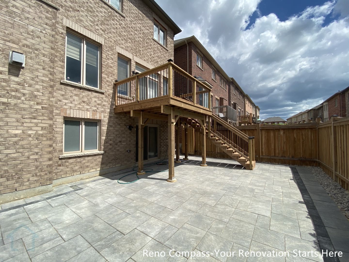 This Markham outdoor renovation features a spacious interlocking stone patio paired with a custom-built raised wooden deck and staircase. Large-format patio stones were installed with precise alignment to create a durable, low-maintenance surface suitable for outdoor seating and everyday use. The elevated deck provides direct access from the home while enhancing the backyard’s functionality and visual structure. Clean transitions between the patio, deck, and fencing create a cohesive outdoor layout that improves circulation and usability. This tiling and deck project was completed by Reno Compass, serving homeowners in Markham and the surrounding GTA.