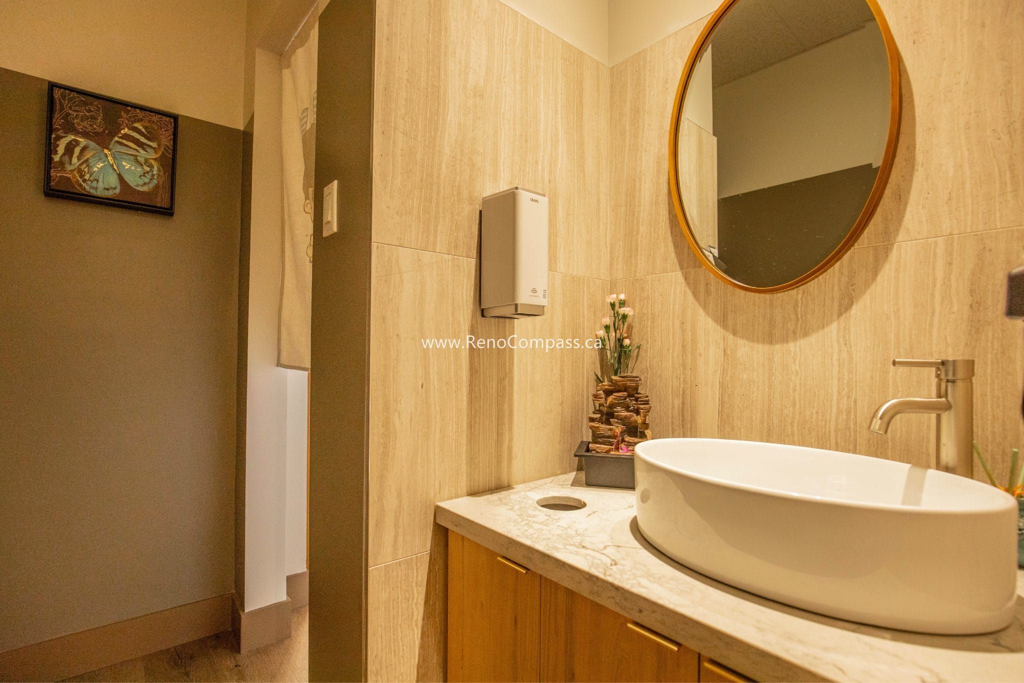 This Richmond Hill Chinese restaurant renovation by Toronto renovation company Reno Compass Inc. includes a modern commercial washroom designed for both functionality and aesthetic appeal. The upgraded space features wood-texture wall finishes, custom vanity cabinetry, a stone countertop, contemporary vessel sink, and warm ambient lighting. Thoughtful material selection and clean design details create a comfortable and hygienic restroom environment, enhancing the overall customer experience and supporting daily restaurant operations with durable, easy-to-maintain finishes.