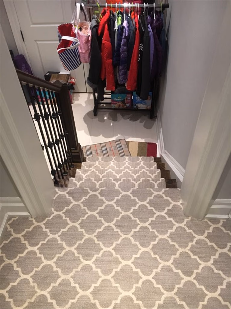 This Toronto interior carpet renovation project showcases a professionally installed staircase carpet runner designed to enhance comfort, safety, and style. The patterned carpet was custom-cut and fitted to align precisely with each stair tread, creating a clean and cohesive look from the upper level to the lower landing.

The neutral-toned runner complements the dark wood stairs and black iron railings, adding warmth while protecting high-traffic areas from wear. Installed by an experienced Toronto renovation company, this staircase carpet upgrade improves daily functionality, reduces noise, and brings a polished, modern finish to the home’s interior stairway.