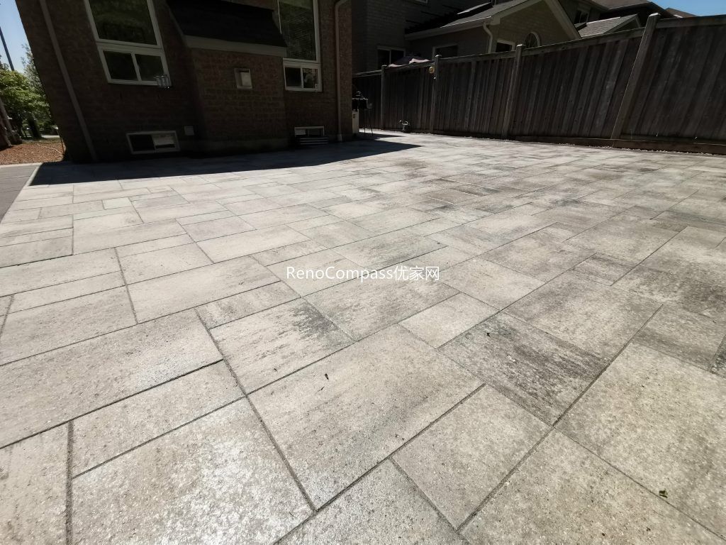 Full view of the completed Mississauga backyard interlocking patio featuring modern large-format stone pavers, clean layout, and spacious outdoor seating area designed for durability and low maintenance.