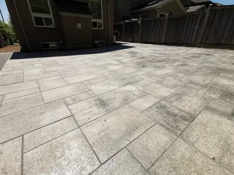 Full view of the completed Mississauga backyard interlocking patio featuring modern large-format stone pavers, clean layout, and spacious outdoor seating area designed for durability and low maintenance.