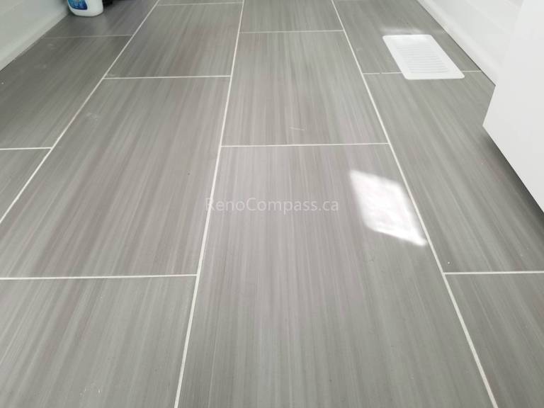 This Toronto interior renovation features high-quality gray porcelain tile flooring with a clean linear pattern and precise grout lines. The durable, low-maintenance tile enhances the space with a modern and elegant finish, ideal for kitchens, bathrooms, or laundry areas. Completed by a professional Toronto renovation contractor, this flooring installation showcases Reno Compass Inc.’s craftsmanship and attention to detail in high-end interior renovations.