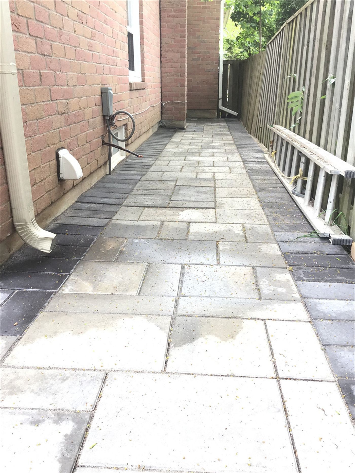 This Oakville interlocking project features a spacious backyard patio built with large-format grey pavers and clean border detailing. The design includes solid step construction leading to the entrance, creating a functional and visually balanced outdoor space. Ideal for relaxing or entertaining, this low-maintenance patio enhances both usability and property value.