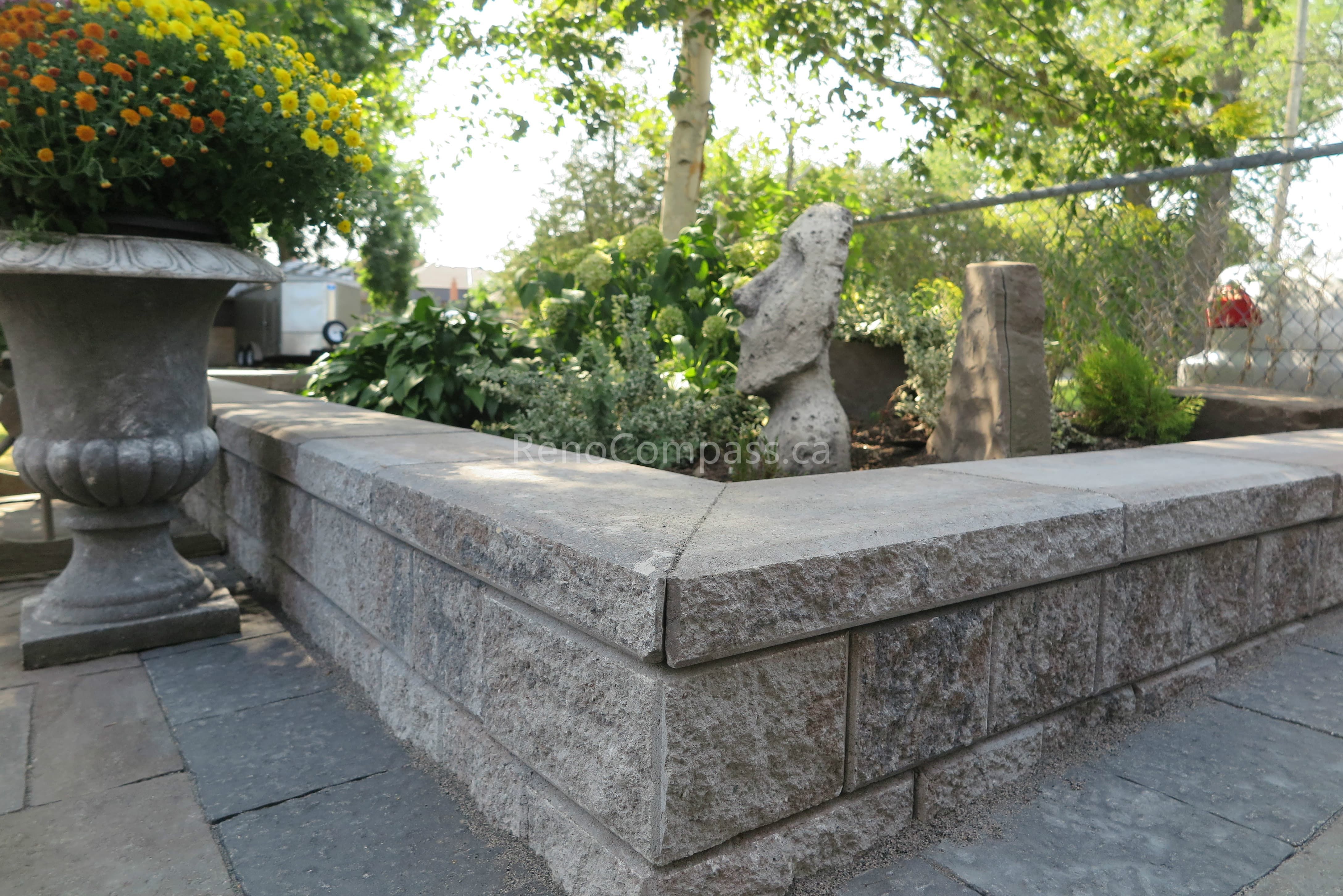 This Mississauga interlocking and landscaping project features a newly upgraded driveway area with professionally constructed retaining walls and front entrance steps. The clean stonework structure improves elevation transition, enhances drainage, and creates a cohesive connection between the driveway and front yard landscape. Designed for both durability and curb appeal, this exterior upgrade was completed by Reno Compass Inc., showcasing quality craftsmanship in residential hardscape and interlocking construction.