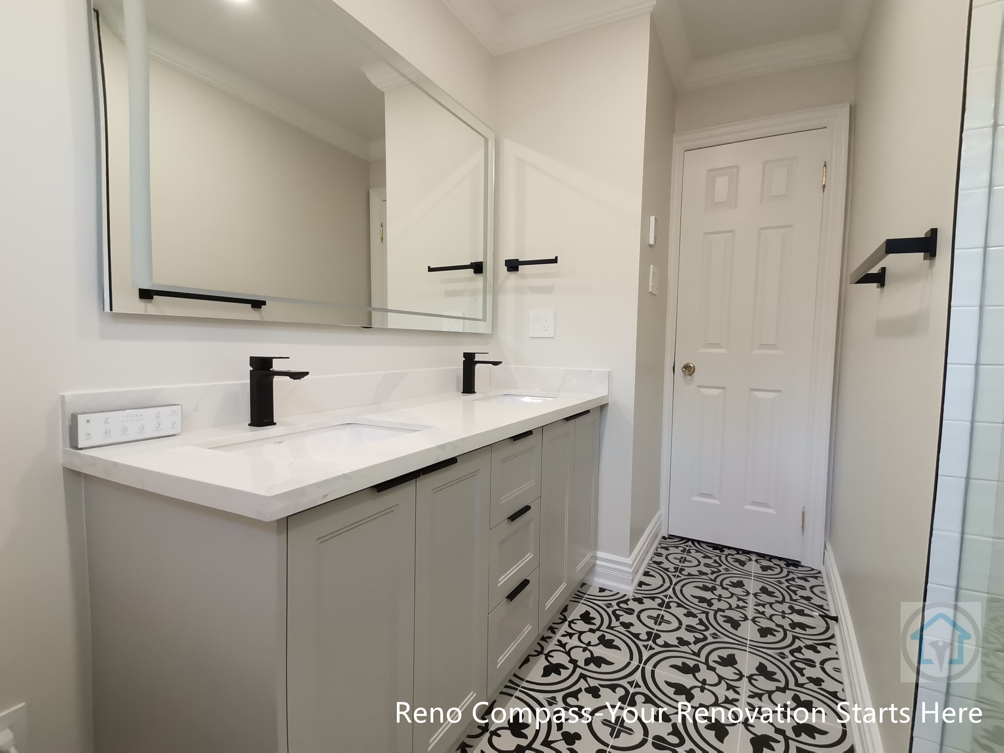 This Thornhill bathroom renovation features a custom double vanity with a quartz countertop, integrated sinks, and matte black faucets. Large mirrored cabinets enhance storage and reflect light, while the patterned tile floor adds visual interest and balance to the clean, neutral palette of the space.