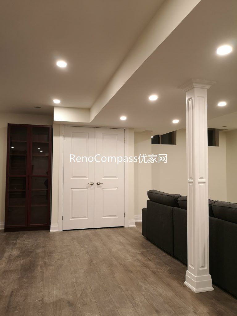 Finished Richmond Hill basement living space featuring open layout, new flooring, modern pot lights, structural column detailing, and custom storage. Renovated by Reno Compass Inc., this basement upgrade enhances comfort, brightness, and multi-functional living space for homeowners.