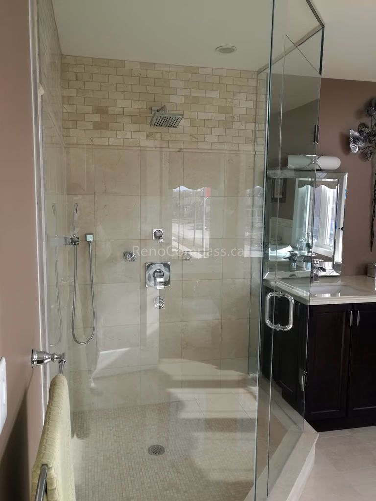 Contemporary bathroom renovation in Toronto featuring a frameless glass walk-in shower, modern tile walls, and custom vanity area. Completed by Reno Compass, this interior renovation enhances functionality, brightness, and a clean spa-inspired design for a stylish and comfortable home bathroom.