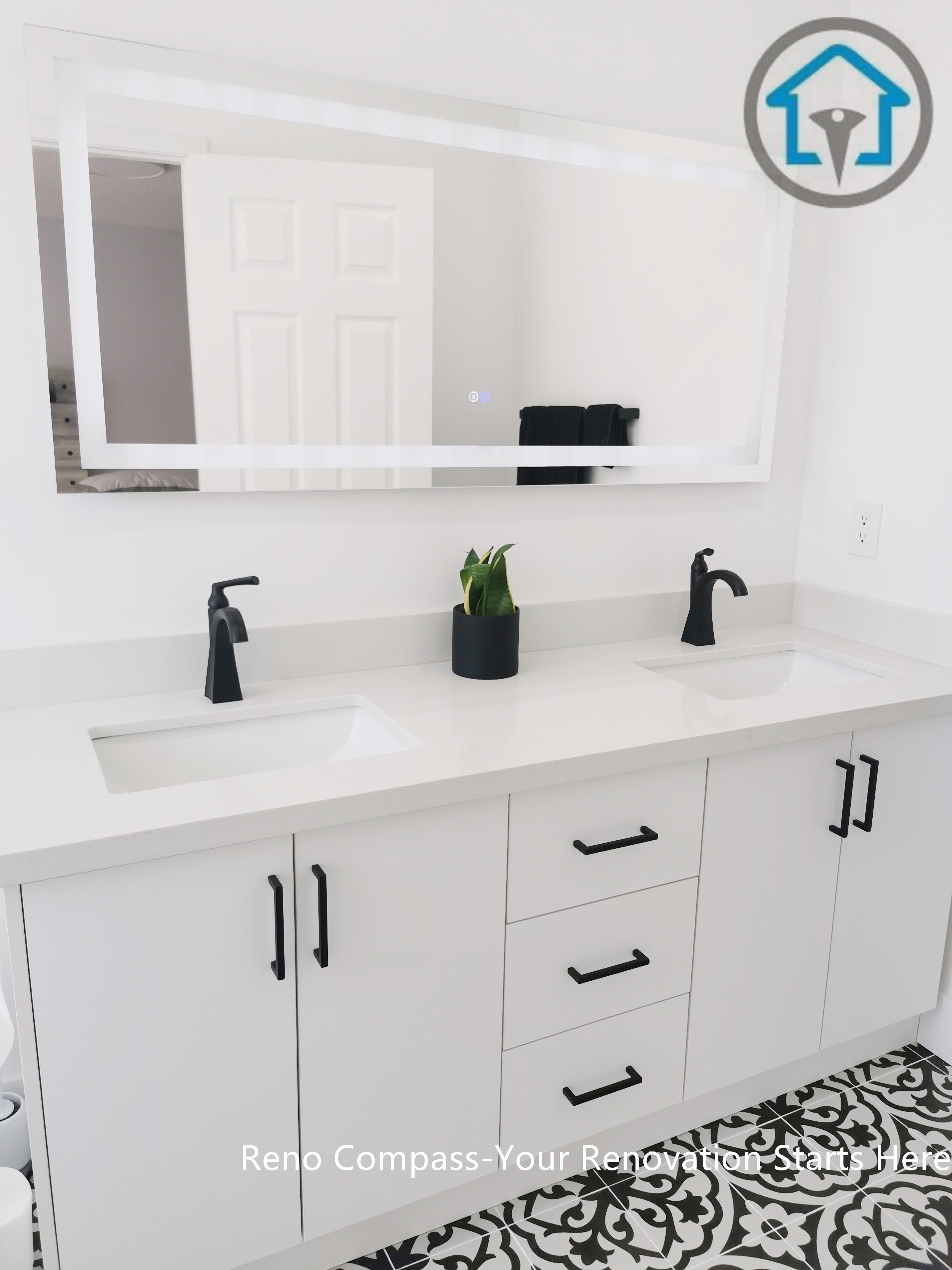 This Ajax bathroom renovation showcases a clean and functional double vanity design with a seamless white countertop and integrated sinks. Matte black faucets and cabinet hardware add strong contrast to the bright cabinetry, while the patterned floor tiles introduce visual interest without overwhelming the space. The layout is designed for daily comfort, combining practical storage with a modern, timeless aesthetic.