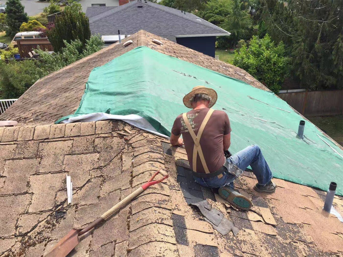 Toronto roofing specialists removing old shingles and preparing the roof structure for a full replacement. This residential roofing project demonstrates safe tear-off procedures, surface inspection, and professional preparation before installing new waterproof layers and shingles. Trusted Toronto roofing contractors delivering reliable roof replacement services across the GTA.