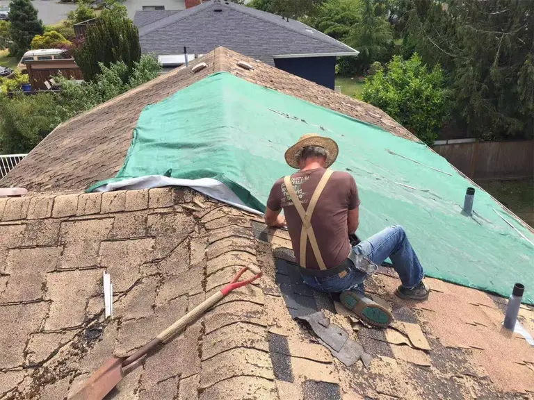 Toronto roofing specialists removing old shingles and preparing the roof structure for a full replacement. This residential roofing project demonstrates safe tear-off procedures, surface inspection, and professional preparation before installing new waterproof layers and shingles. Trusted Toronto roofing contractors delivering reliable roof replacement services across the GTA.