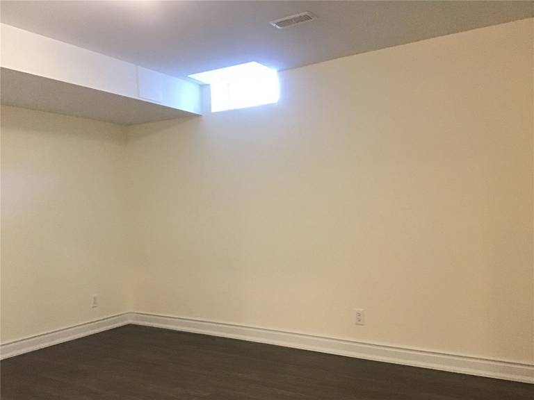 A clean and modern finished basement renovation in Mississauga featuring durable engineered wood flooring, fresh neutral wall finishes, and upgraded baseboards for a bright and comfortable living space. This project by a trusted Toronto Renovation Company demonstrates how professional basement remodeling can transform unused space into a functional and elegant area suitable for entertainment, family living, or a home office.