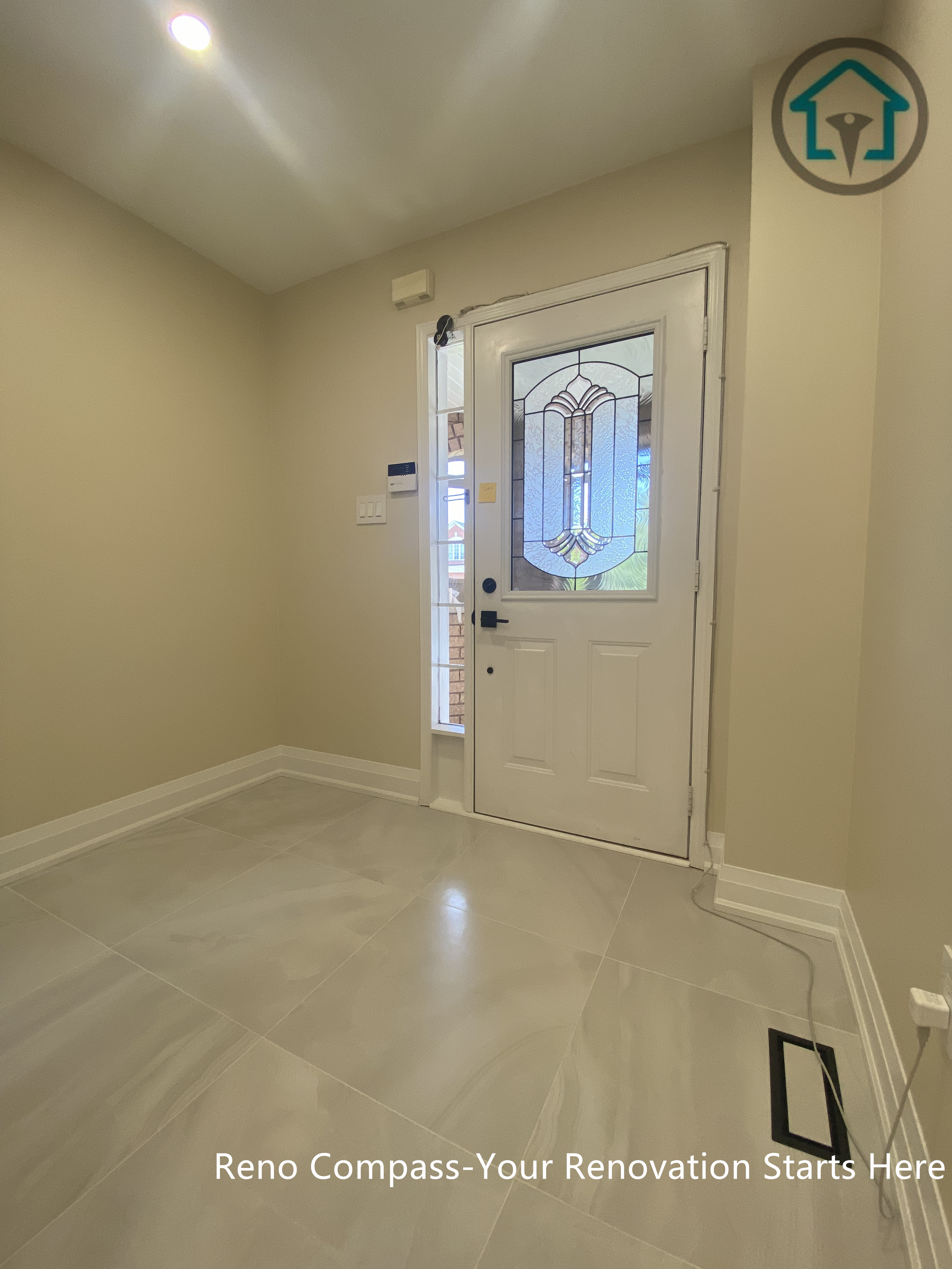 Entryway view from a completed interior renovation project in Vaughan, featuring a clean layout and functional flooring design by Reno Compass.