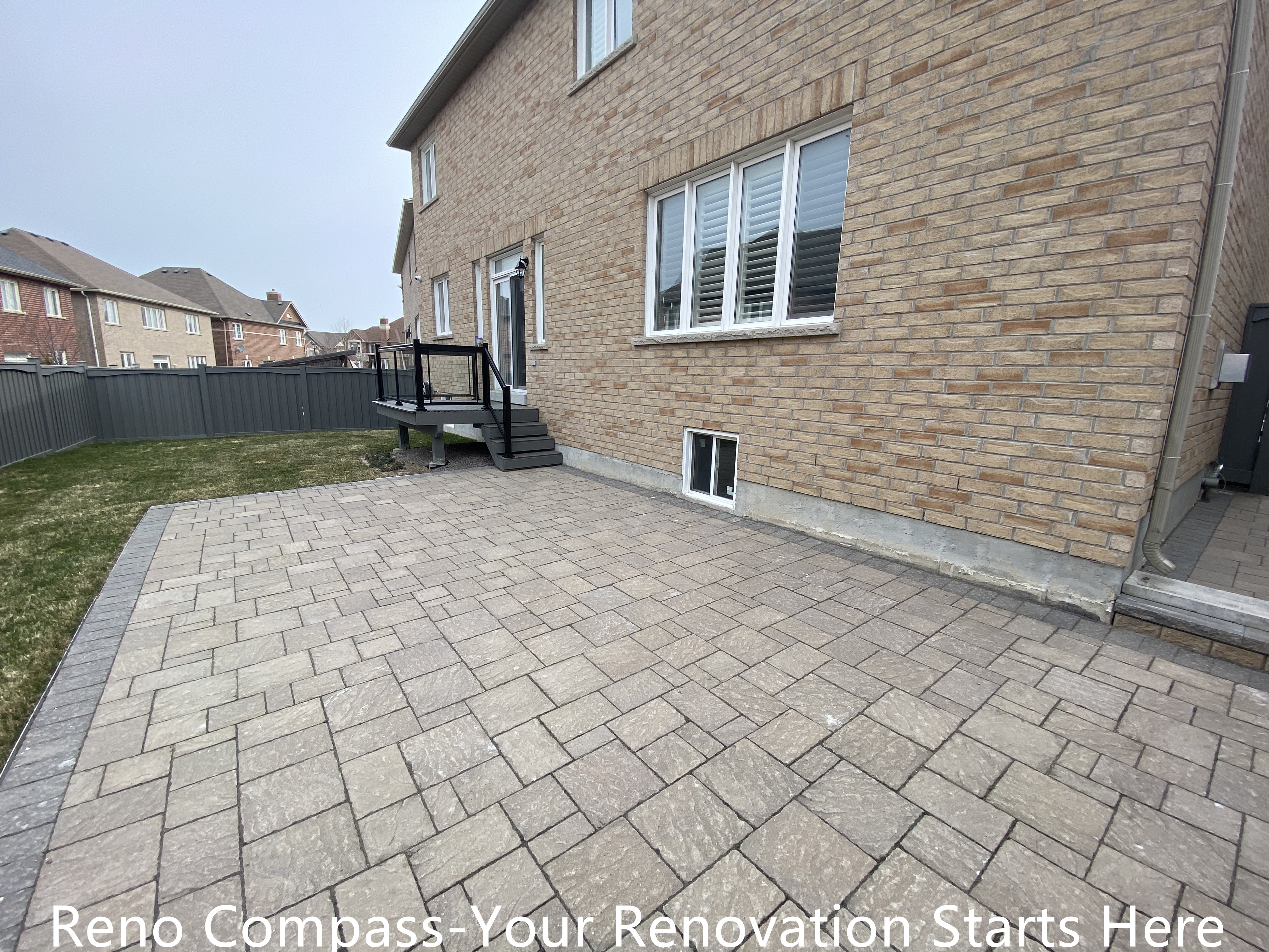 Backyard interlocking patio renovation in Newmarket featuring a large, level paved surface designed for outdoor seating, recreation, and low-maintenance use. The clean layout and durable concrete pavers enhance usability, drainage performance, and overall backyard functionality. Completed by a professional Toronto renovation company specializing in high-quality residential exterior renovations.