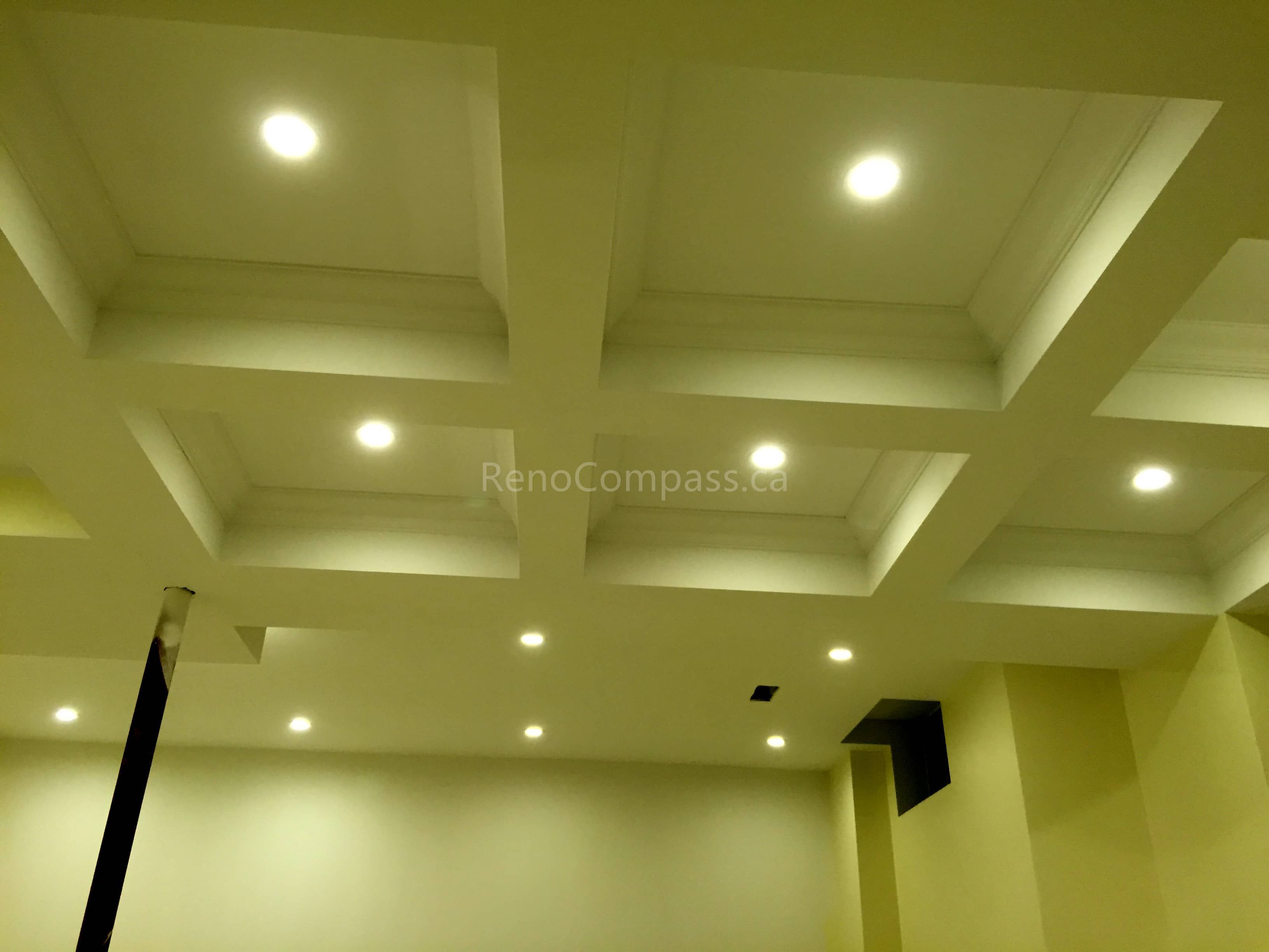 This Toronto interior renovation by Reno Compass features a custom coffered ceiling design paired with recessed LED pot lights for a refined and modern finish. The structured ceiling layout enhances architectural depth while improving overall lighting distribution throughout the space. With precise craftsmanship and clean detailing, this ceiling upgrade adds elegance, brightness, and long-term value to the home’s interior design.