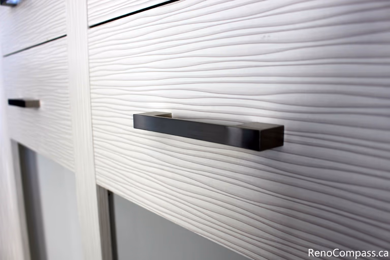 This close-up cabinet detail highlights the custom storage installed during a full house renovation in Mississauga by a professional Toronto renovation company. Featuring textured cabinet panels and sleek modern handles, the design adds both visual interest and functionality to the interior space. The renovation focuses on high-quality craftsmanship, contemporary finishes, and practical storage solutions that enhance everyday living and overall home value.