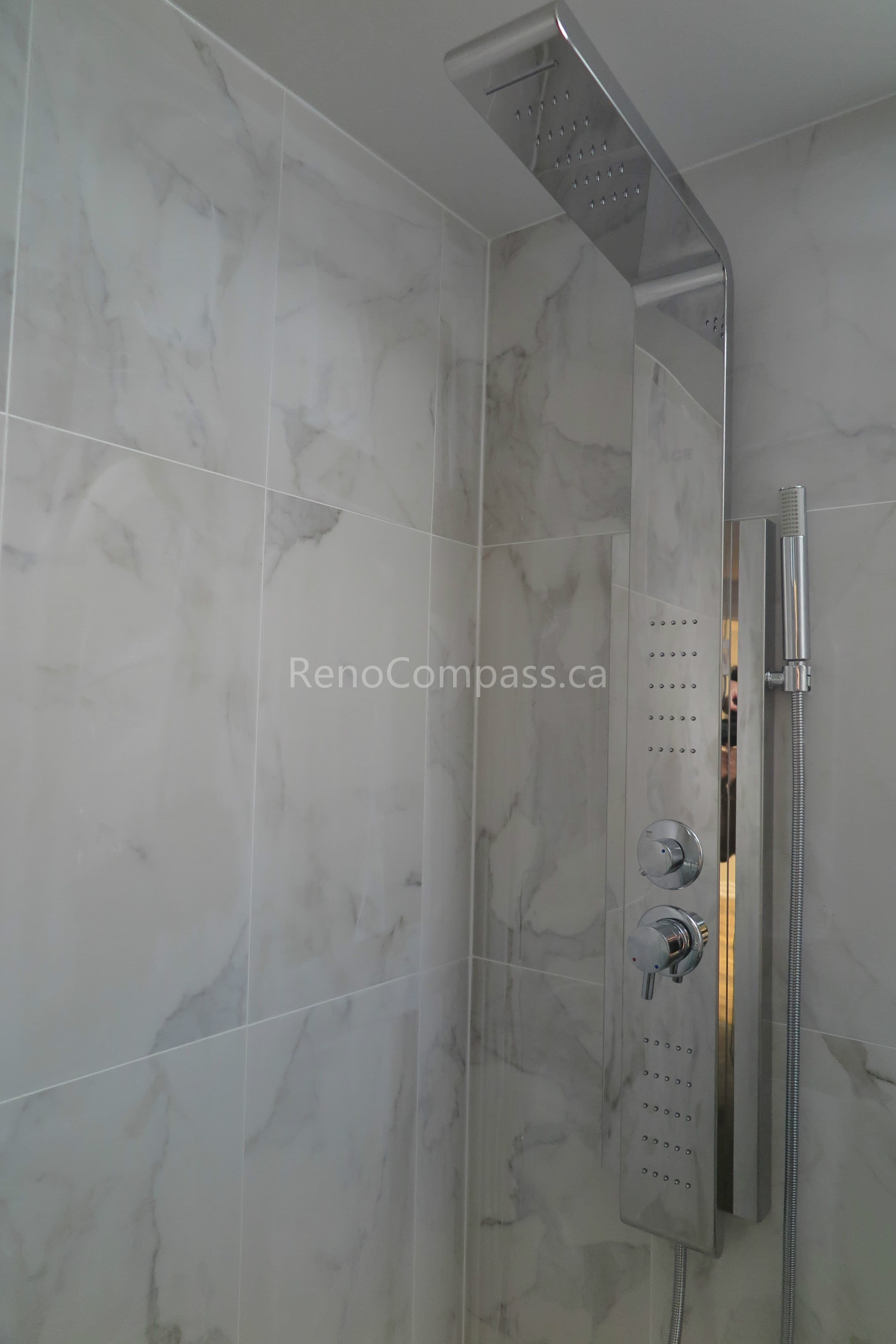 This North York interior renovation features a luxury bathroom shower upgrade with a modern rainfall shower system, handheld fixture, and marble-style wall tiles. Installed by a professional Toronto renovation company, Reno Compass delivers precise waterproofing, high-end fixture installation, and refined finishing details to create a spa-inspired and functional bathroom experience for homeowners.