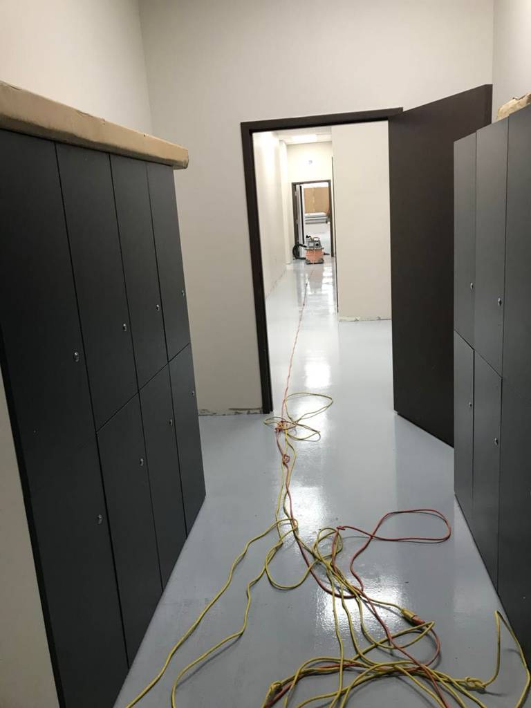 This Toronto commercial renovation highlights a clean and functional office corridor transformation featuring newly installed storage cabinets and seamless grey epoxy flooring. The durable floor coating enhances safety, longevity, and easy maintenance, making it ideal for high-traffic commercial environments. The refreshed layout improves workflow efficiency while maintaining a modern, professional appearance suitable for offices, clinics, warehouses, or retail back-of-house operations in the GTA.