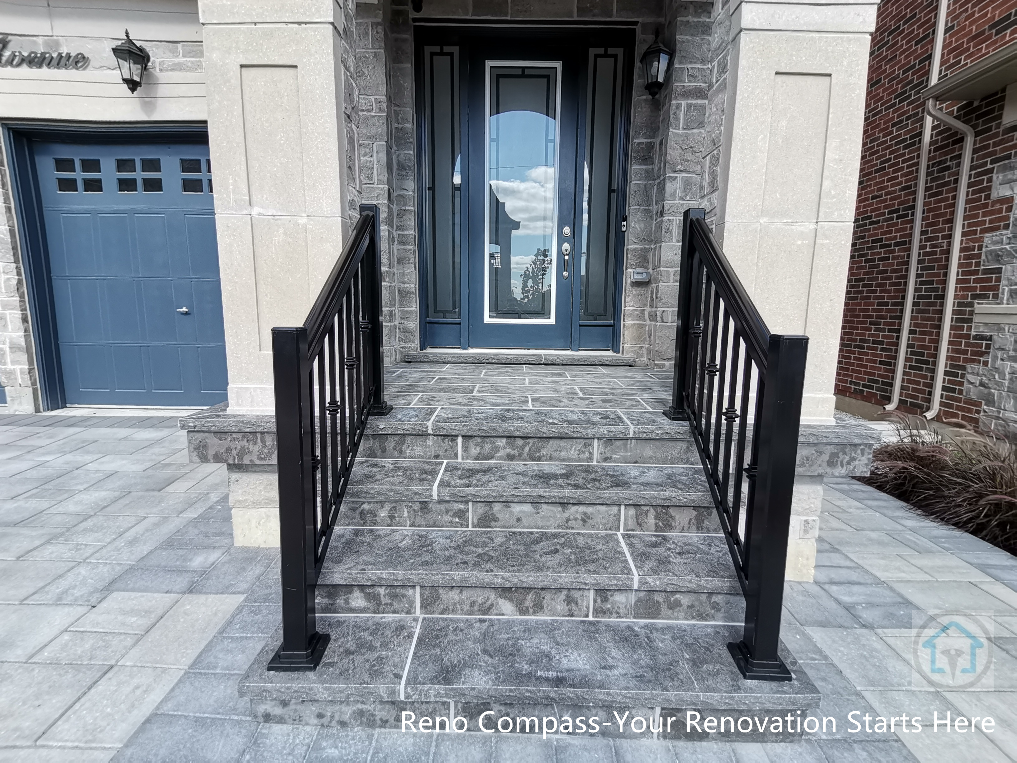 This Vaughan front entrance renovation highlights custom stone steps and a structured walkway leading to the main door. The natural stone finish, clean joint lines, and black metal railings create a refined and durable entry experience that seamlessly connects the driveway with the home’s front façade.