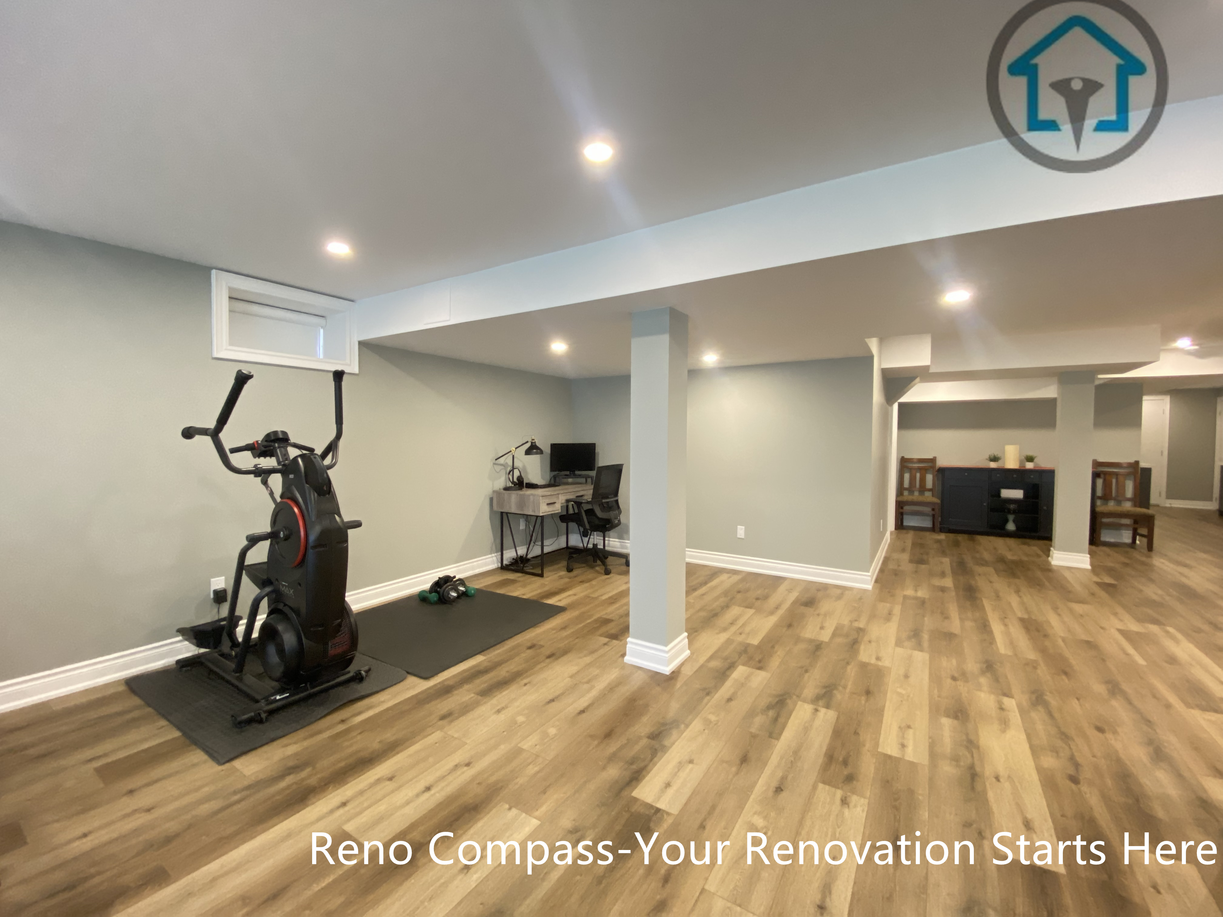 A versatile multi-purpose area completed as part of a Vaughan basement renovation. This finished basement space is designed to accommodate a home gym, workout zone, or home office, with recessed ceiling lighting, clean structural column integration, and durable wood flooring.