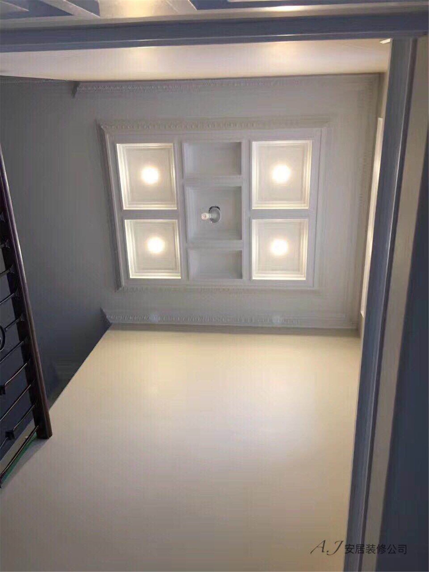 Architectural coffered ceiling above the staircase featuring recessed LED lighting and decorative trim detailing. This Toronto interior renovation enhances the vertical space with elegant ceiling craftsmanship and balanced lighting by a professional Toronto renovation company.
