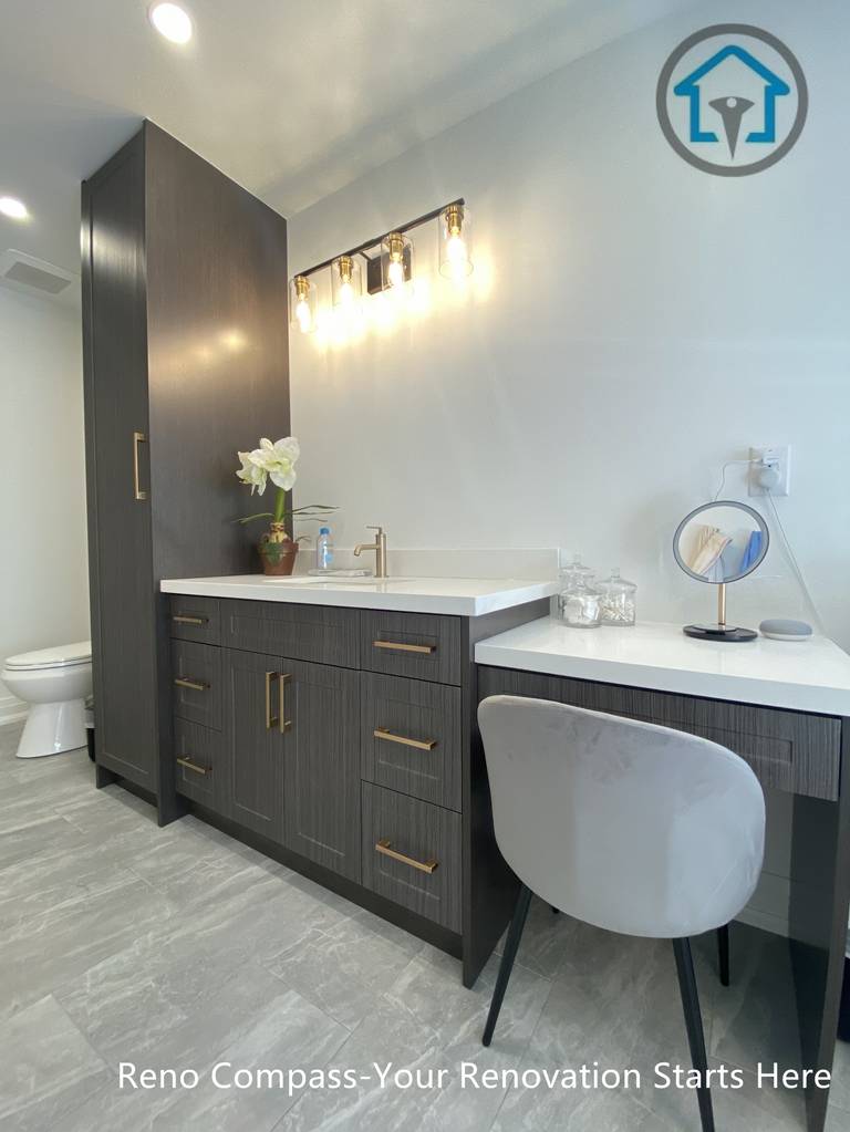 Custom vanity with integrated makeup area, textured cabinetry, quartz countertop, and warm accent lighting in a Markham bathroom renovation.