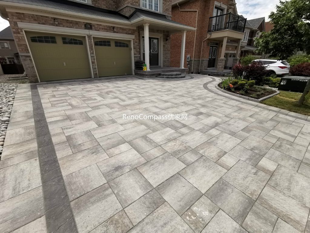 Beautifully designed interlocking driveway in Vaughan with a modern grey stone pattern. Expertly installed by Reno Compass, featuring durable pavers, clean lines, and low-maintenance landscaping to enhance curb appeal.