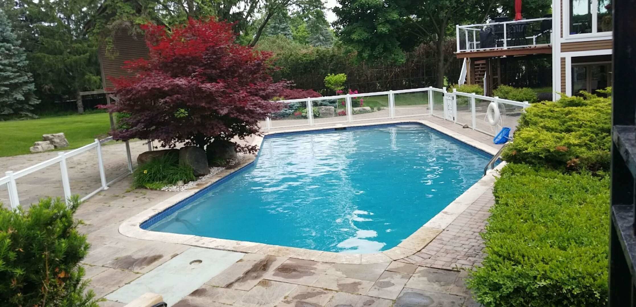After renovation photo of a fully restored backyard swimming pool in Toronto. The new bright blue liner, clean water, and resurfaced edges highlight the professional pool transformation from old and damaged to modern and inviting. Expert pool renovation by local Toronto specialists.