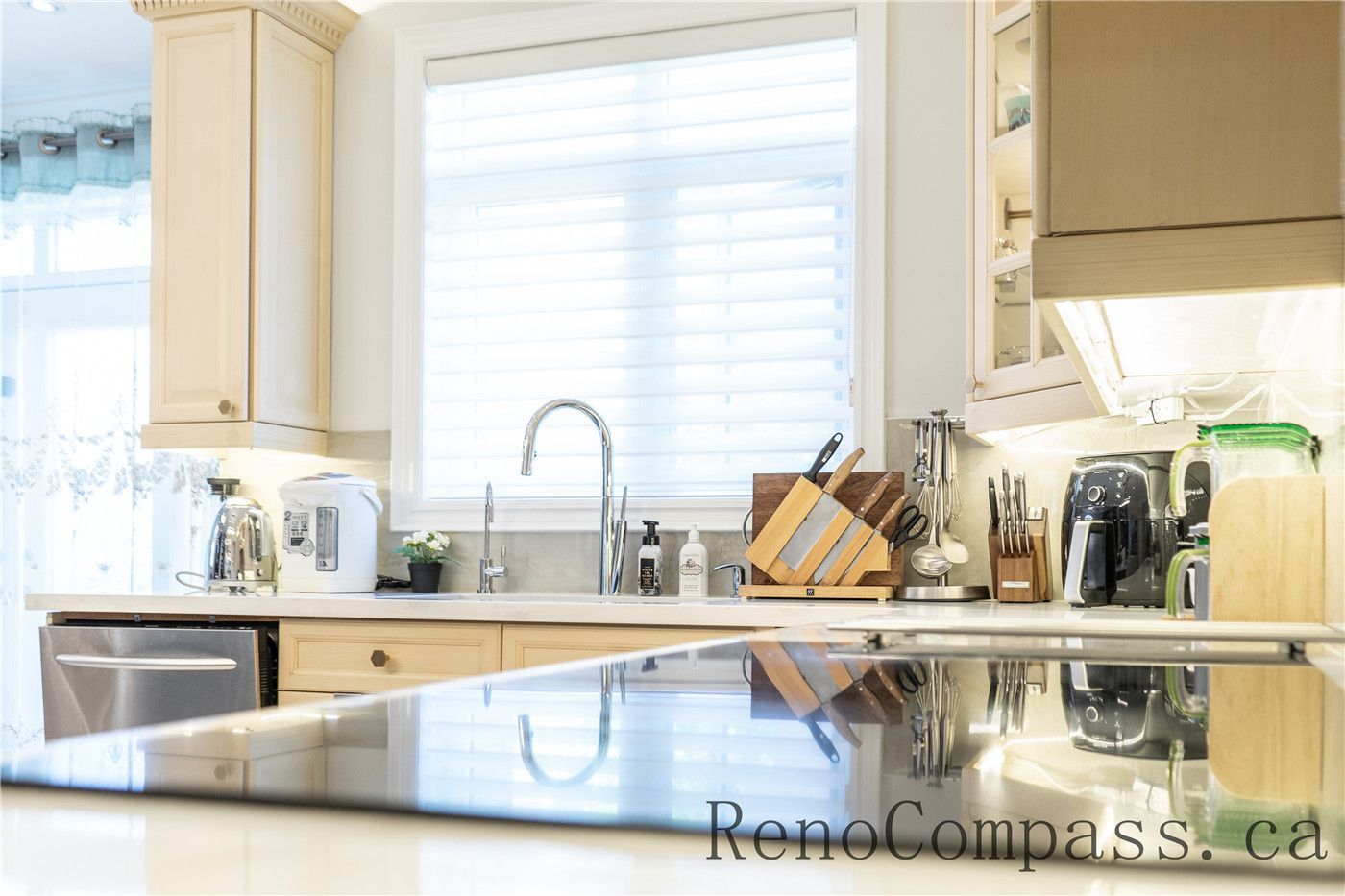 This Richmond Hill kitchen renovation highlights a bright and functional cooking space with quartz countertops, custom cabinetry, modern sink fixtures, and built-in appliances. The clean layout and natural lighting enhance daily usability while maintaining a timeless design, reflecting the quality workmanship of a professional Toronto renovation company delivering complete home interior upgrades.