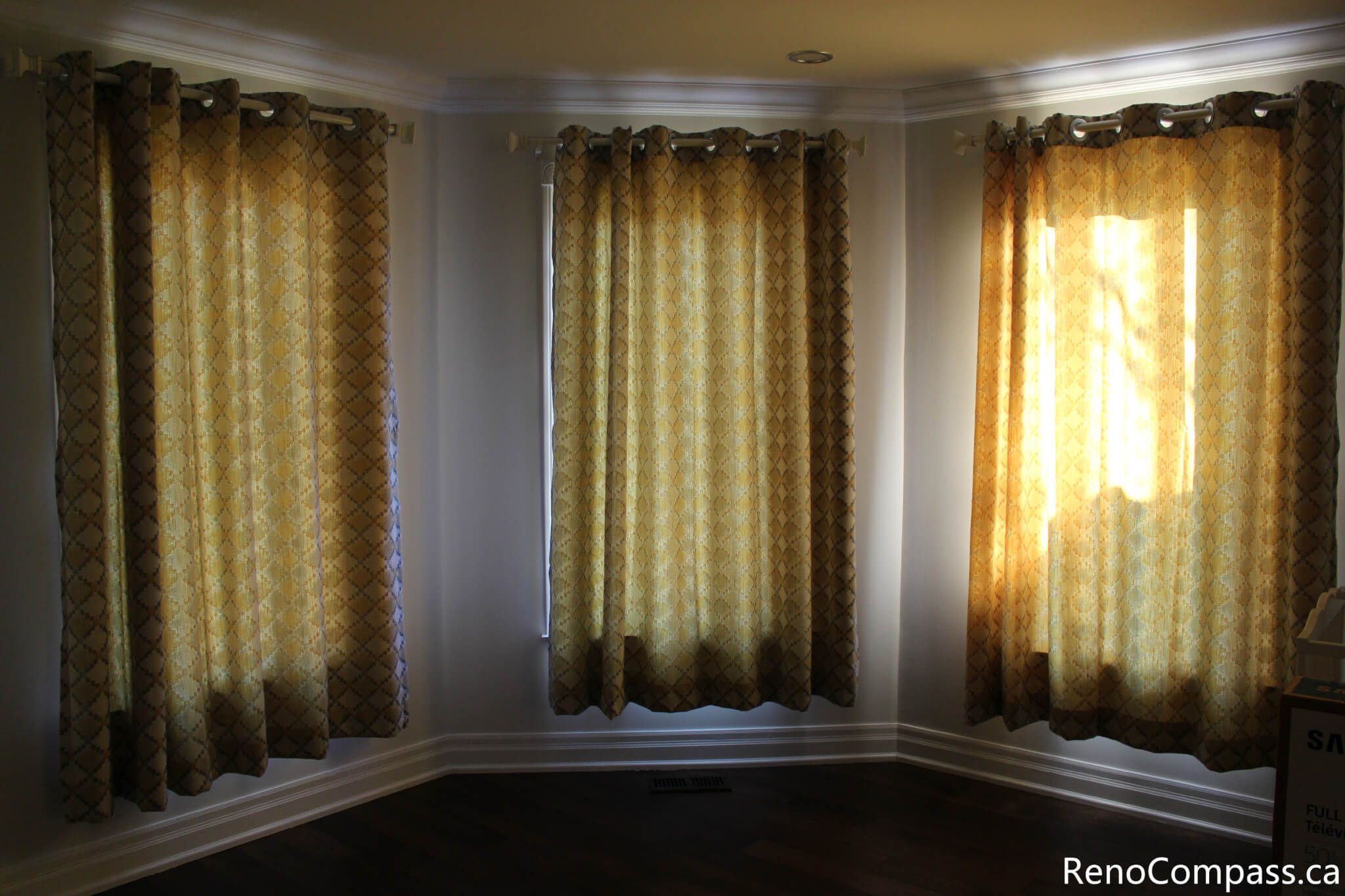 This Mississauga interior renovation highlights a bright bay window living space enhanced with custom curtain installation, detailed trim work, and rich hardwood flooring. The upgraded windows improve natural light control while adding warmth and elegance to the room. Completed by a trusted Toronto renovation company, Reno Compass Inc., this project showcases refined interior finishing and professional craftsmanship.