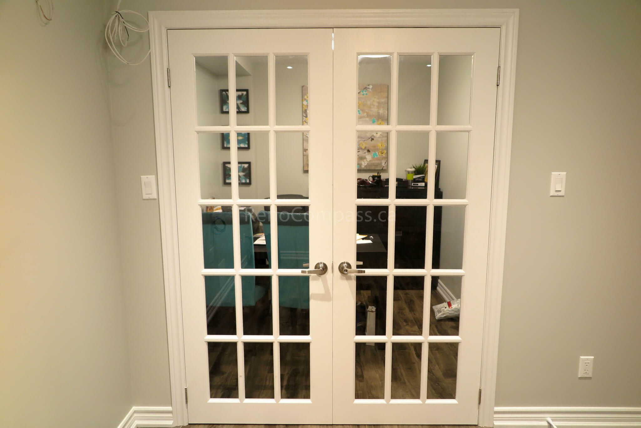 Elegant French doors installed in a renovated Richmond Hill basement, adding a touch of natural light, openness, and sophistication to the modern design.