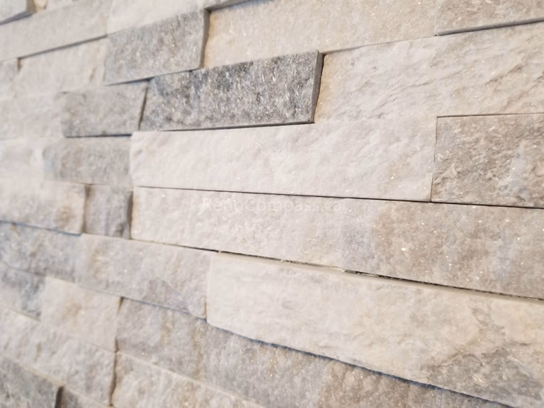 Close-up detail of a modern stacked stone feature wall from a Mississauga interior renovation project. The neutral-toned stone texture adds depth, elegance, and a contemporary luxury feel to the living space.

Installed by Reno Compass Inc., this custom interior wall finish enhances the home’s visual appeal while creating a sophisticated focal point that complements modern fireplace and living room designs.