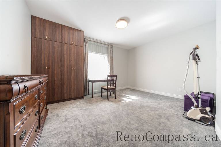 This Richmond Hill entire house interior renovation includes a refreshed bedroom featuring soft carpeting, large windows for natural light, and custom storage cabinetry. Clean neutral finishes and a simple layout create a comfortable and versatile living space suitable for guests or family use. Completed by a reliable Toronto renovation company, this bedroom renovation enhances comfort, functionality, and overall home value.