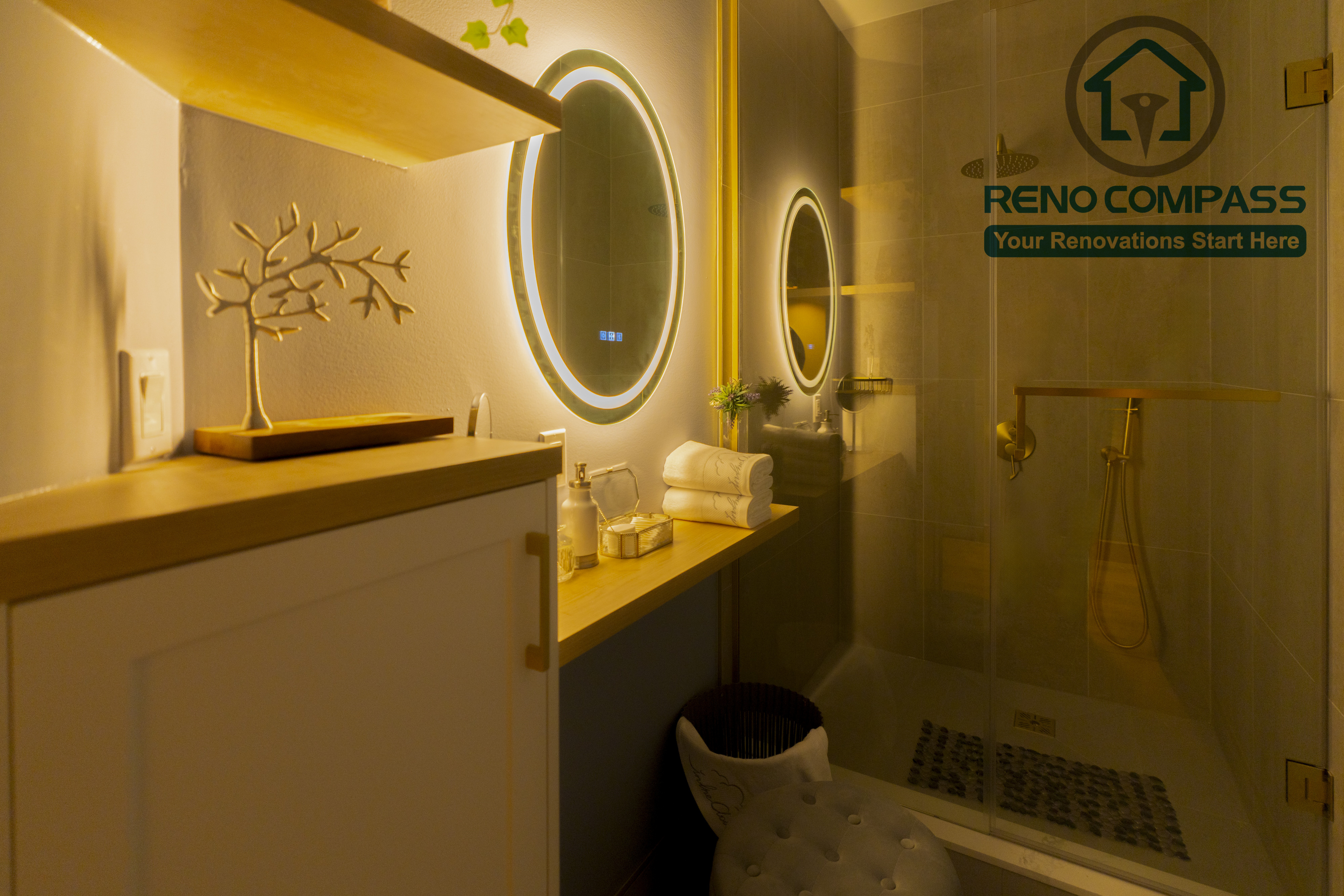 Spa-style washroom completed as part of a North York beauty salon renovation. This space features illuminated round mirrors, custom vanity storage, warm accent lighting, and a glass shower enclosure with refined fixtures. Designed to enhance cleanliness, comfort, and a calming client experience by a professional Toronto renovation company.