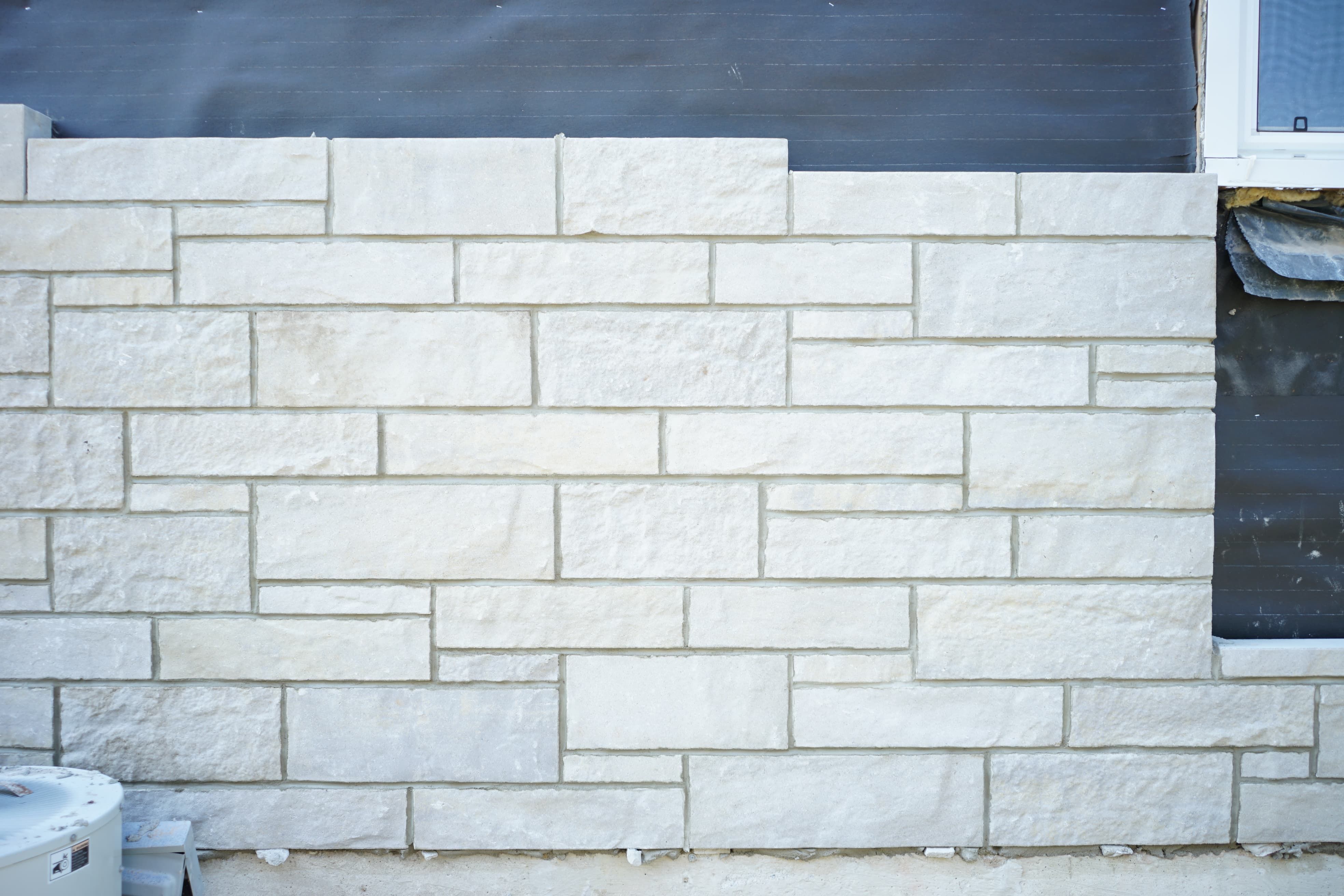 Professional exterior wall remodeling project in Richmond Hill showcasing a refreshed brick façade using high-quality finishes.