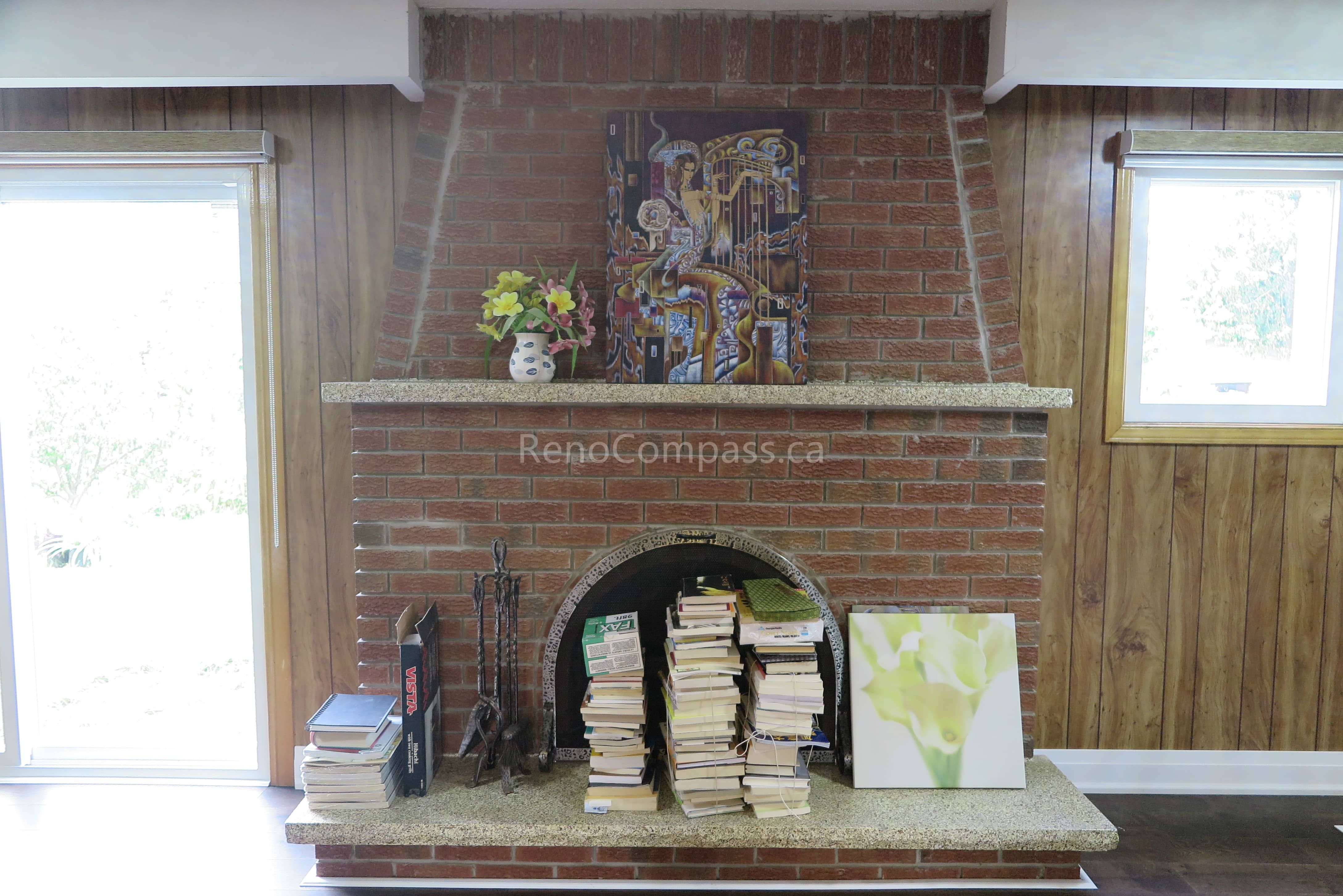 This Toronto interior renovation features a classic brick fireplace with a custom stone mantel and warm wood panel wall finishes. The upgraded living space blends traditional charm with modern comfort, creating a cozy focal point for the home. Completed by a trusted Toronto renovation contractor, this project highlights Reno Compass Inc.’s expertise in fireplace upgrades, interior finishing, and full home renovation craftsmanship.