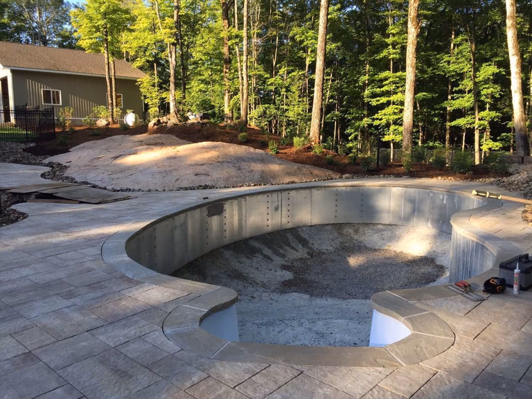 Custom backyard swimming pool construction in Toronto featuring professional steel pool structure installation and foundation preparation. This stage highlights precise pool framing, base leveling, and site grading to ensure long-term durability and structural stability for a high-quality residential swimming pool project.