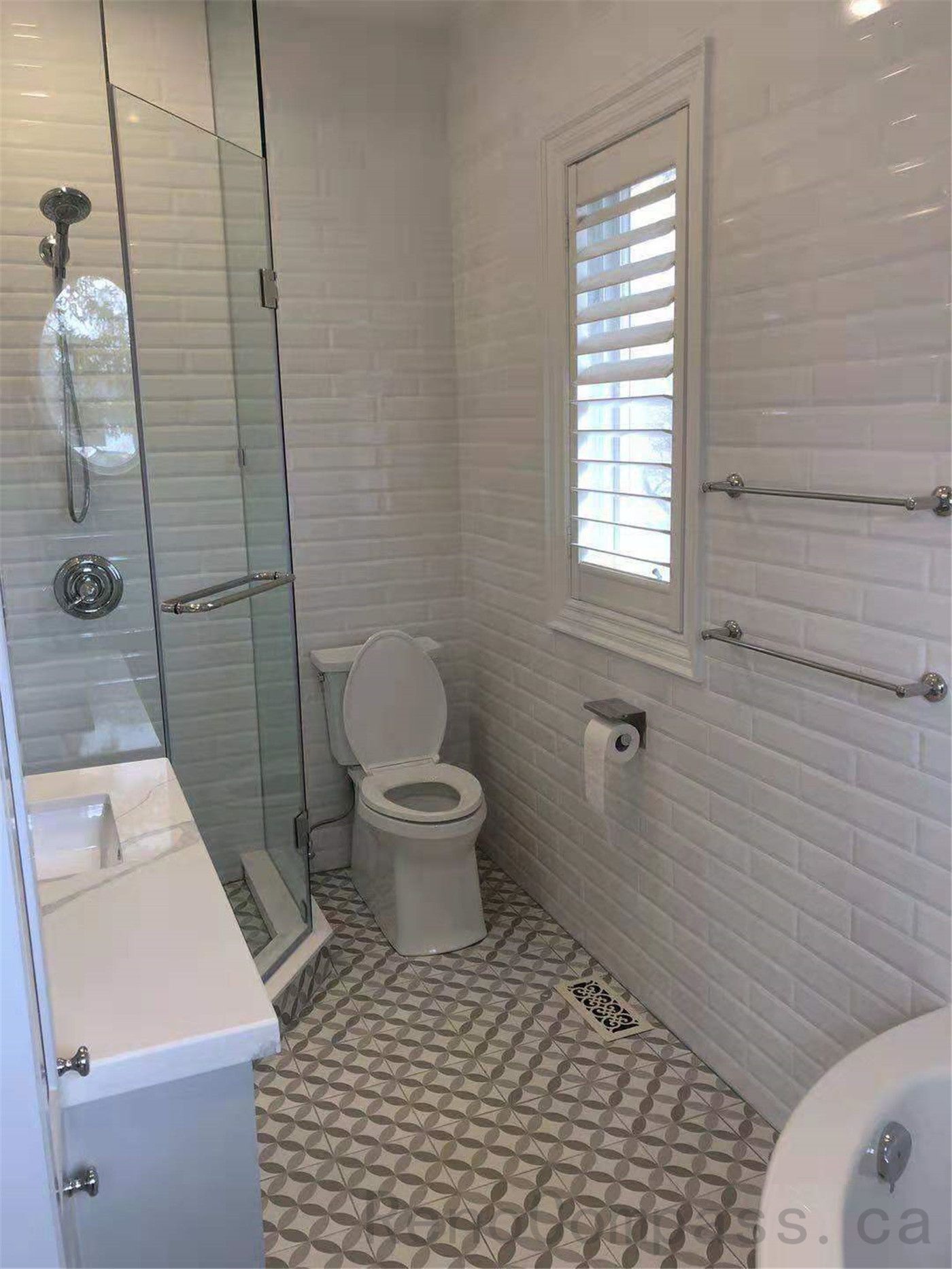This North York bathroom renovation features a modern glass shower enclosure, classic white subway wall tiles, and geometric patterned floor tiles that add character and visual interest. The bright layout improves functionality and comfort while maintaining a clean contemporary style. Completed by a professional Toronto renovation company focused on quality craftsmanship and practical bathroom design.