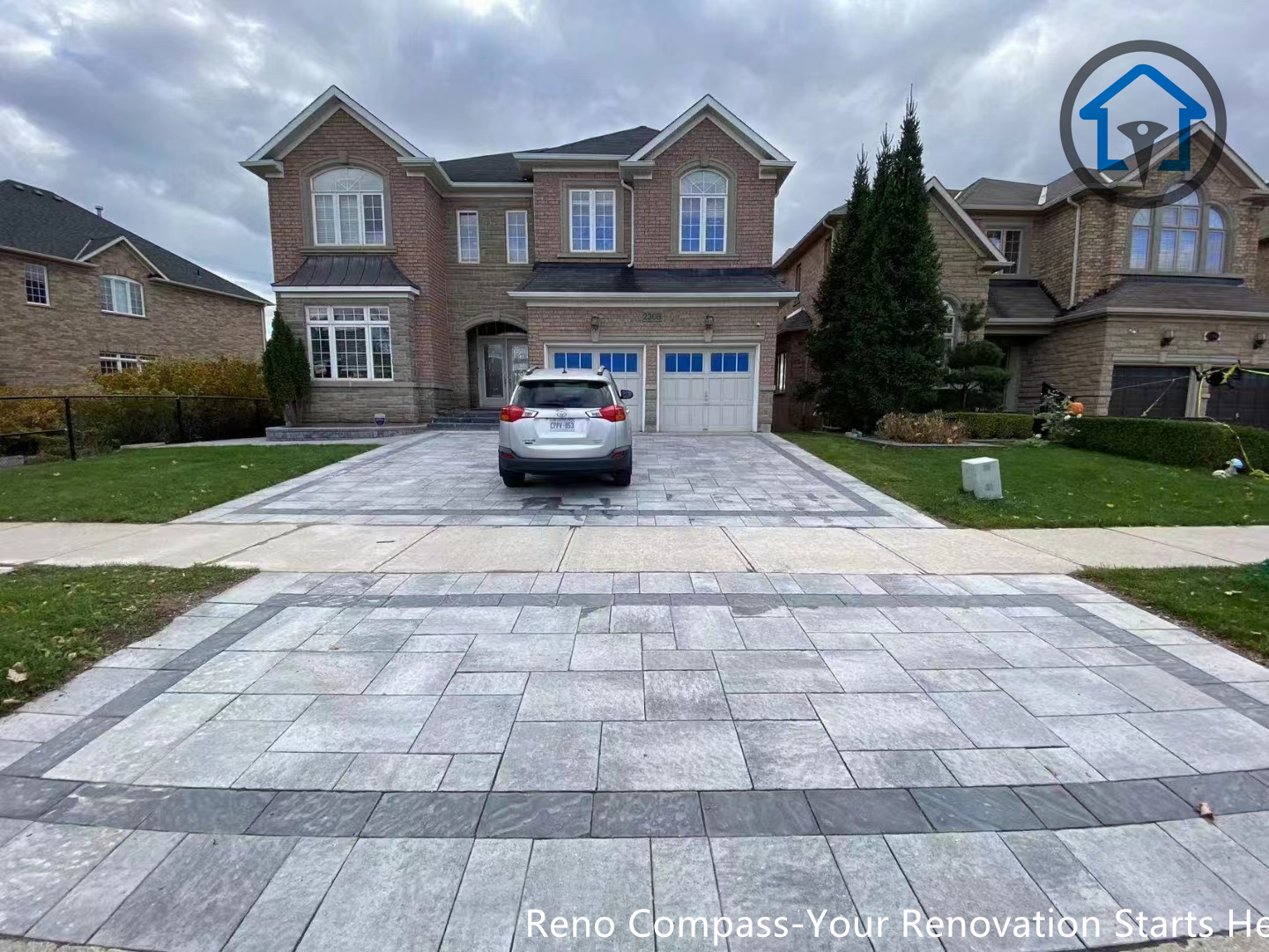 This image showcases a completed interlocking driveway and front patio paving project in Oakville, featuring large-format stone pavers with clean linear patterns. The design enhances curb appeal while providing a durable, low-maintenance outdoor surface suitable for Canadian weather. Completed by Reno Compass Inc., this project demonstrates professional craftsmanship in residential interlocking, driveway paving, and front yard patio renovation.