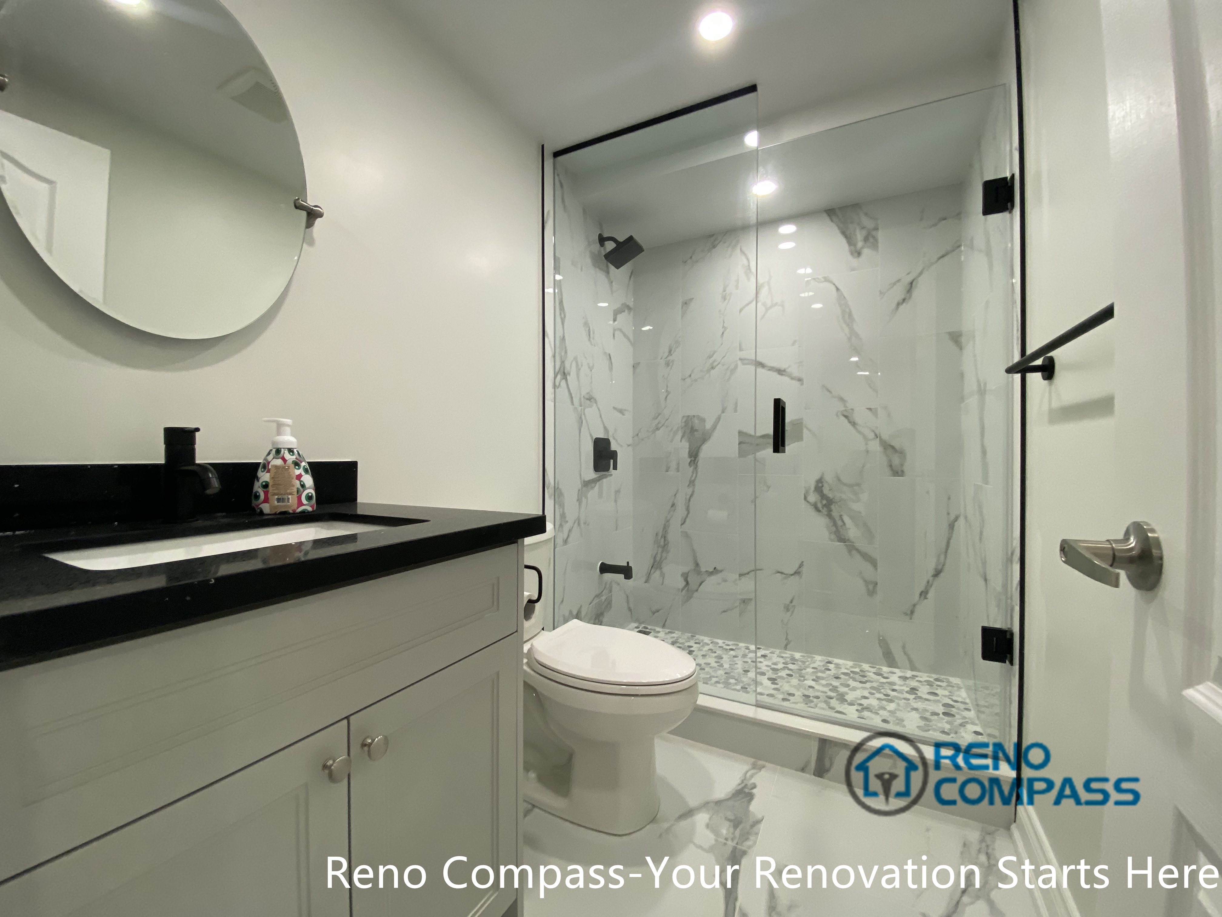 A completed basement bathroom vanity area in Aurora showcasing a contemporary and minimalist design. The streamlined vanity, practical storage, and balanced lighting improve everyday usability while maintaining a clean and timeless basement renovation aesthetic.