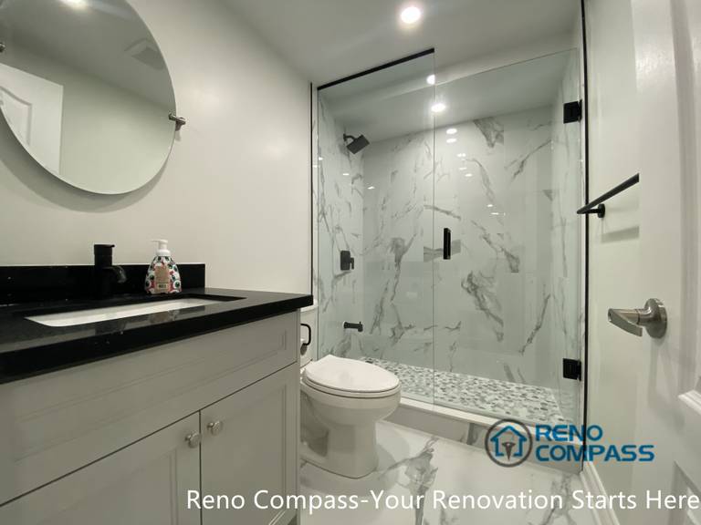 A completed basement bathroom vanity area in Aurora showcasing a contemporary and minimalist design. The streamlined vanity, practical storage, and balanced lighting improve everyday usability while maintaining a clean and timeless basement renovation aesthetic.