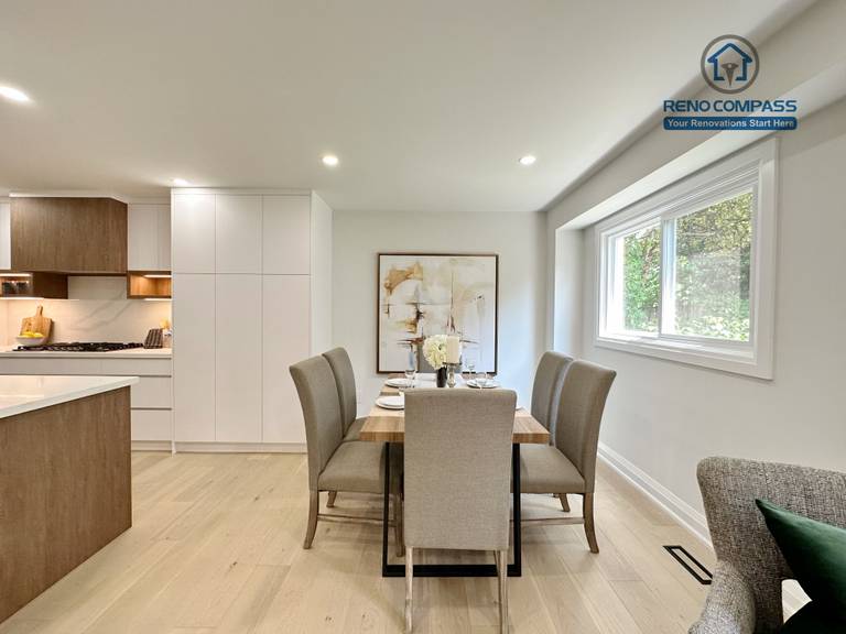 This Richmond Hill interior renovation features a modern dining area seamlessly connected to an open-concept kitchen. Light hardwood flooring, recessed ceiling lighting, and large windows create a bright and welcoming space for everyday dining and entertaining. Completed by a Toronto renovation company, the design emphasizes comfort, flow, and contemporary residential living.