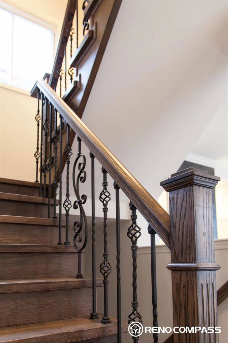 This Markham interior renovation highlights a beautifully crafted staircase featuring rich solid wood steps paired with elegant wrought iron balusters. The combination of warm wood tones and intricate metal detailing creates a timeless yet modern look, enhancing both the functionality and visual appeal of the home.