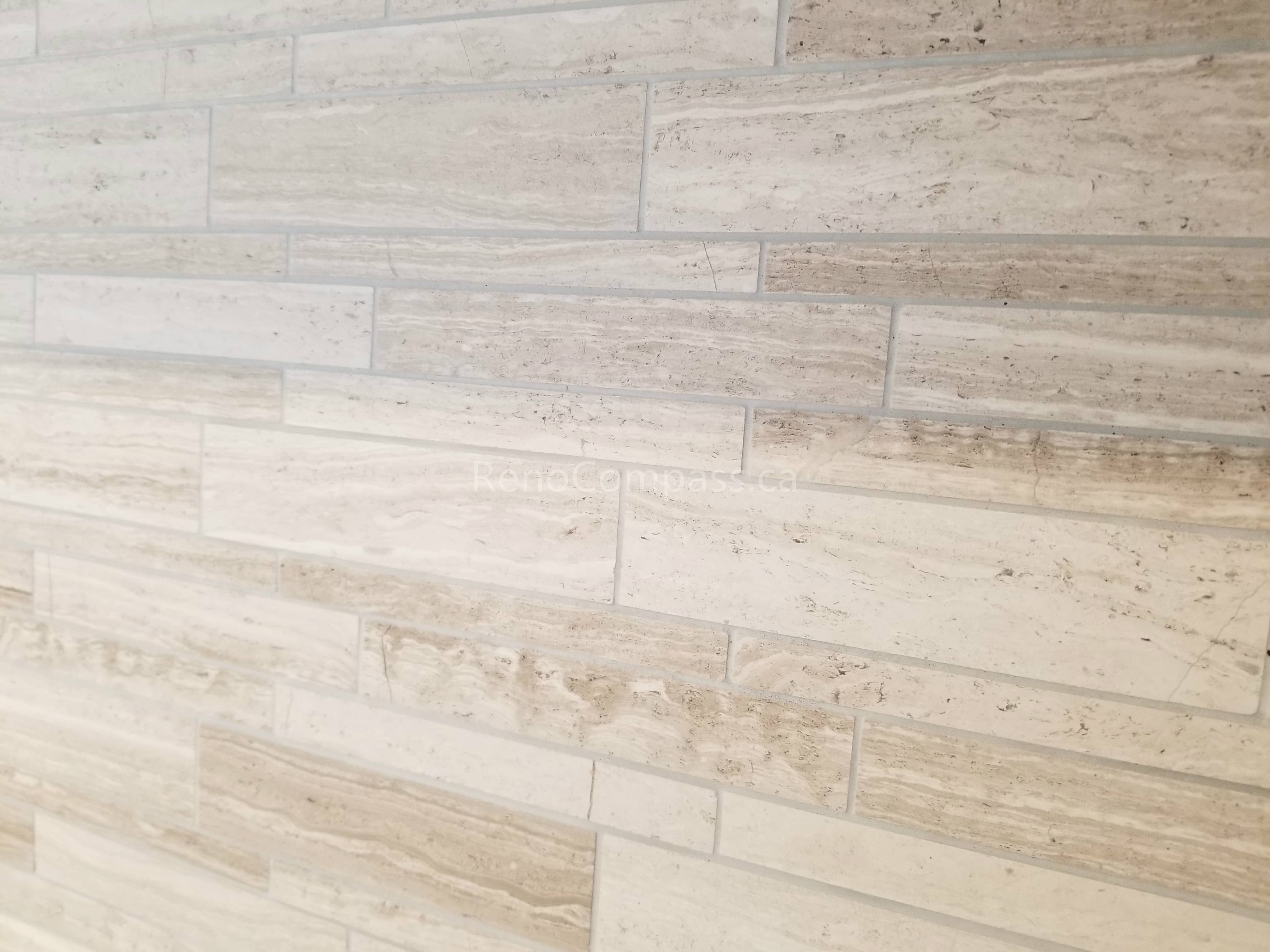 This Mississauga interior renovation features a modern textured wall tile installation that adds depth, warmth, and contemporary character to the space. The natural-toned horizontal tiles create a stylish accent wall that enhances visual interest while maintaining a clean and elegant design.

Completed by Reno Compass Inc., this professional tile installation showcases quality craftsmanship and refined finishing details, elevating the overall interior aesthetic and property value.