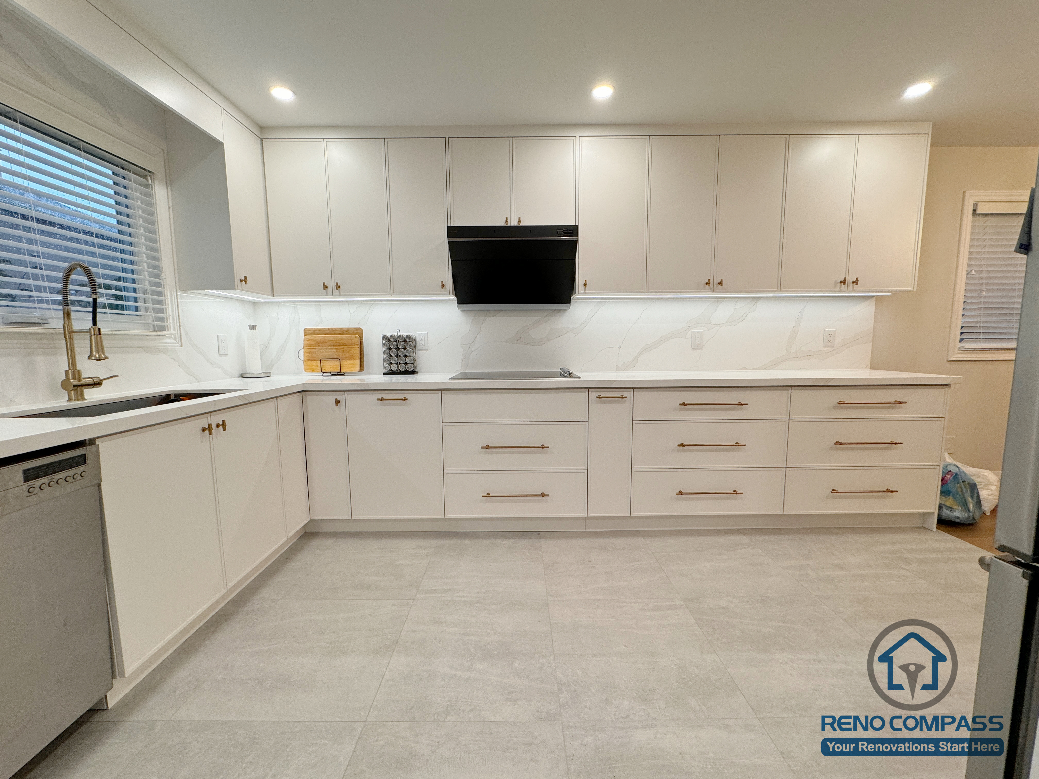 This Mississauga kitchen renovation features full-height white cabinetry, streamlined hardware, and a clean, functional layout. Integrated appliances, continuous quartz backsplash, and recessed lighting create a bright, cohesive space designed for everyday cooking and long-term use.